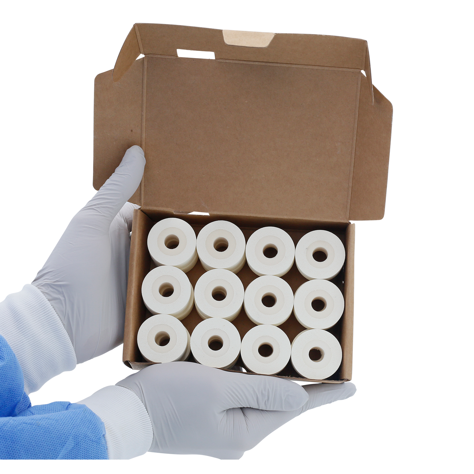 A person holding a card box open with 24 16mm white hot DAX ink rolls inside.