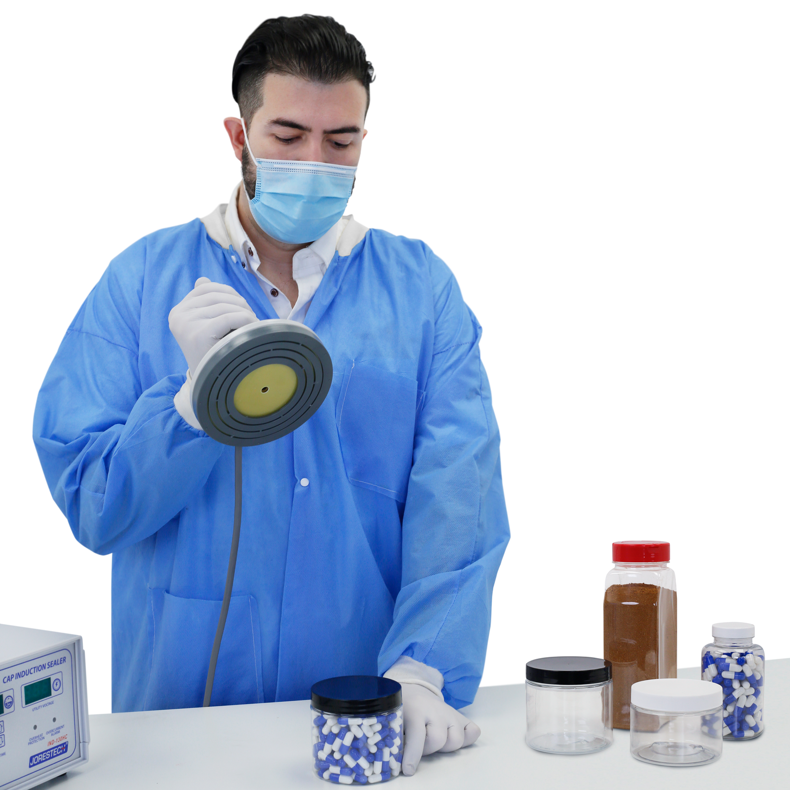 Person in a lab wearing personal protection equipment sealing a bottle of pills using the Jorestech induction cap sealer for temper protection