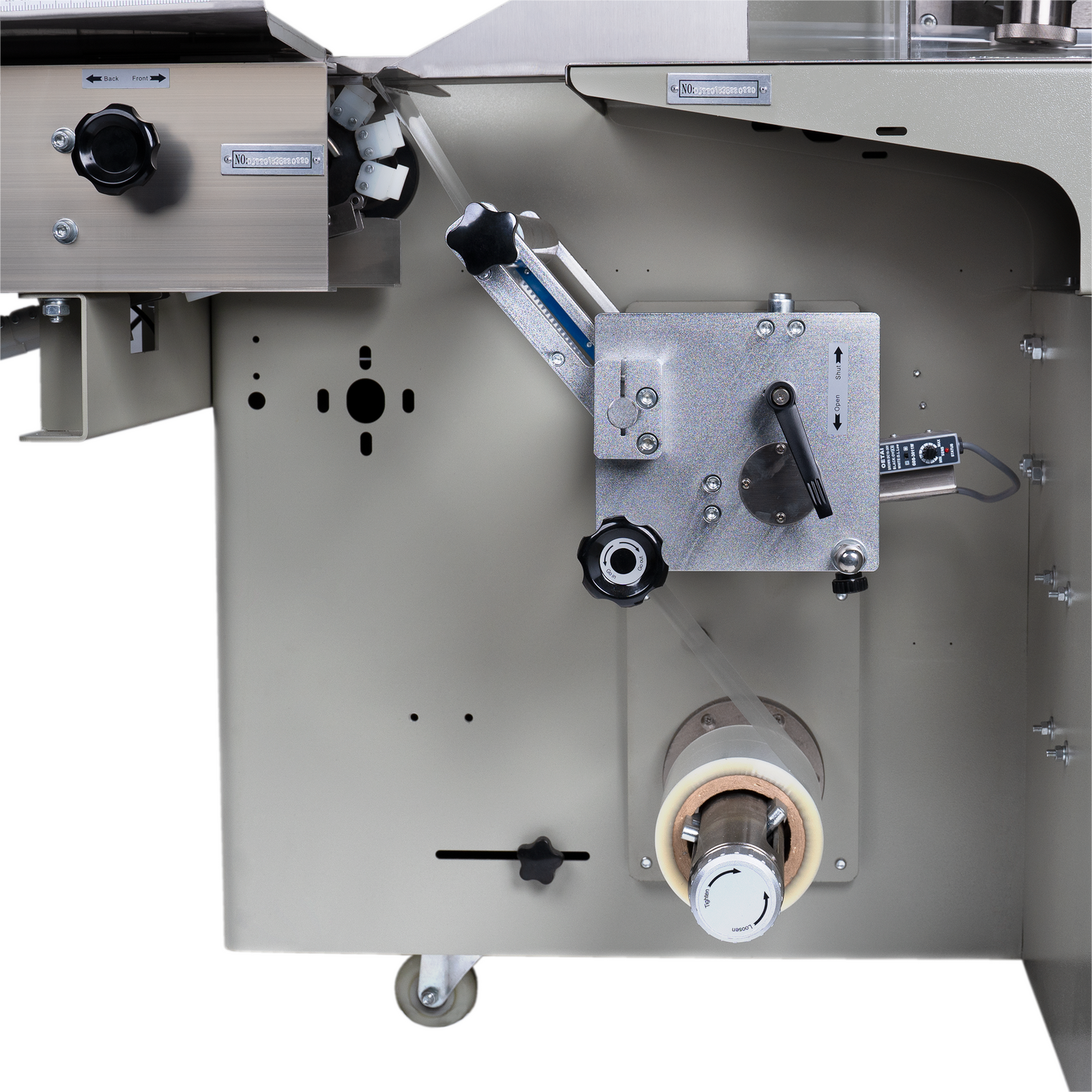 Close up showing a plastic dispenser roll installed into the automatic horizontal flow wrapper with inverted film feeder