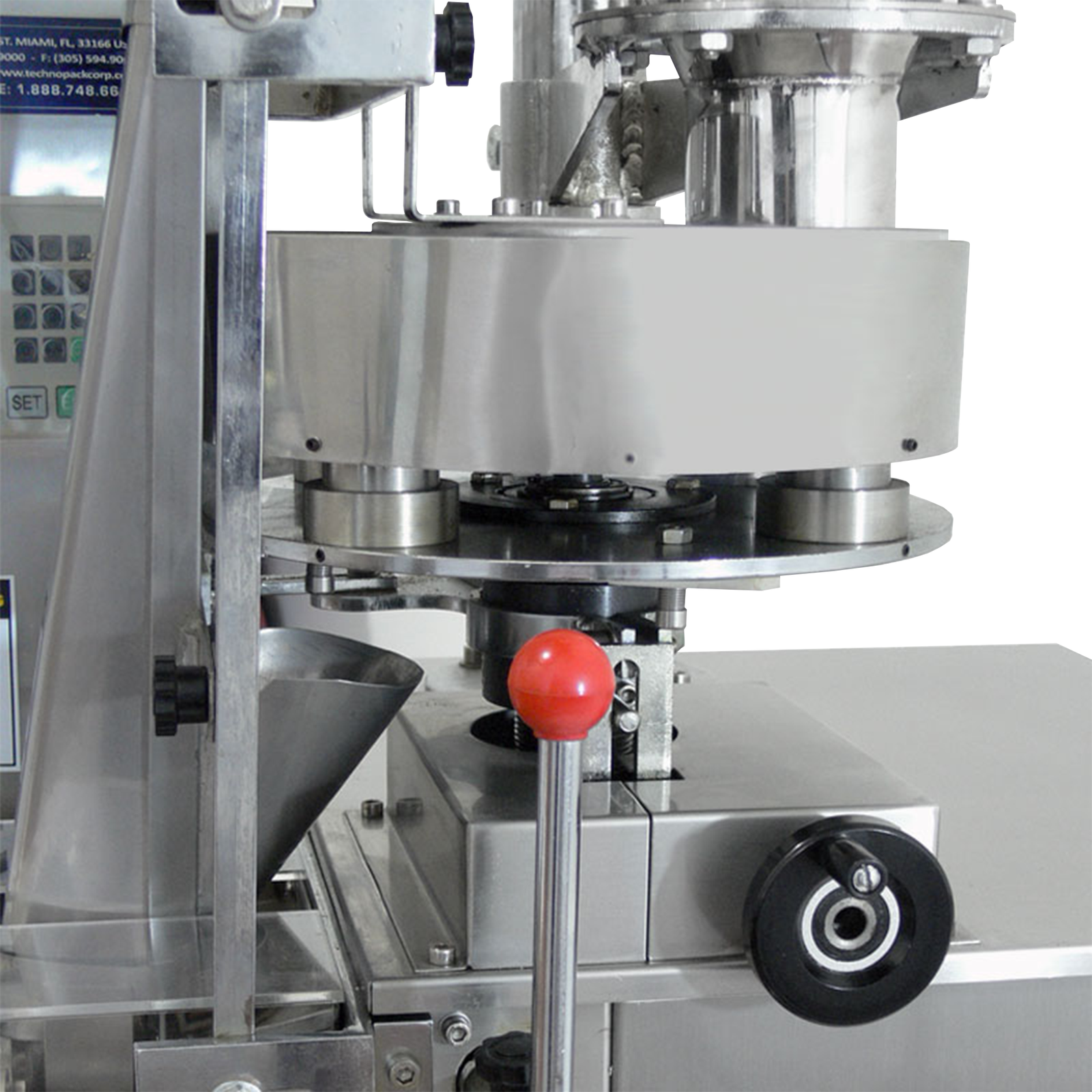 Close-up detail shot of the rotating plate with telescopic volumetric measuring cups on a JORES TECHNOLOGIES® VFFS packaging system.