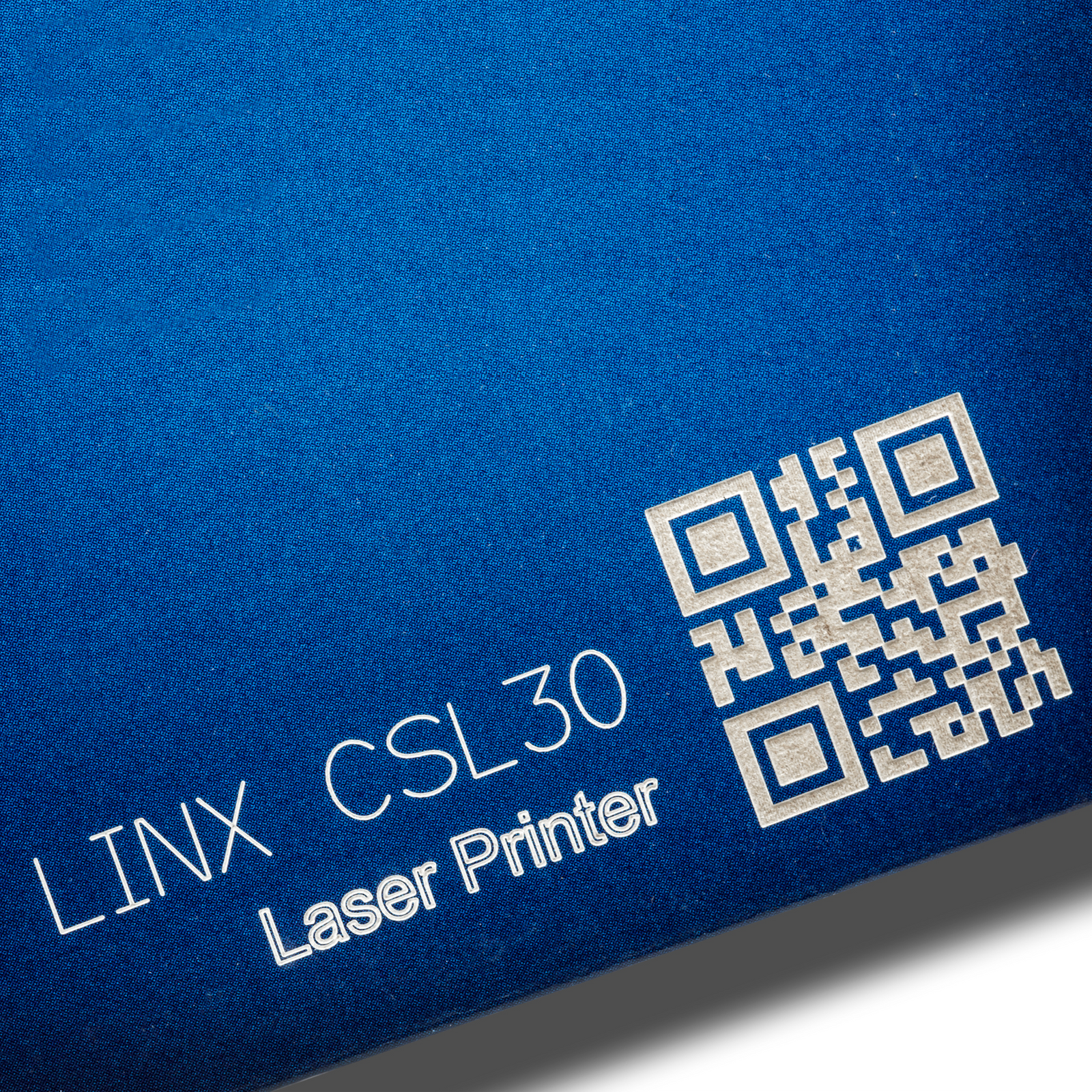 Blue card marked with letters and a QR code done with a CSL30 LINX laser coder