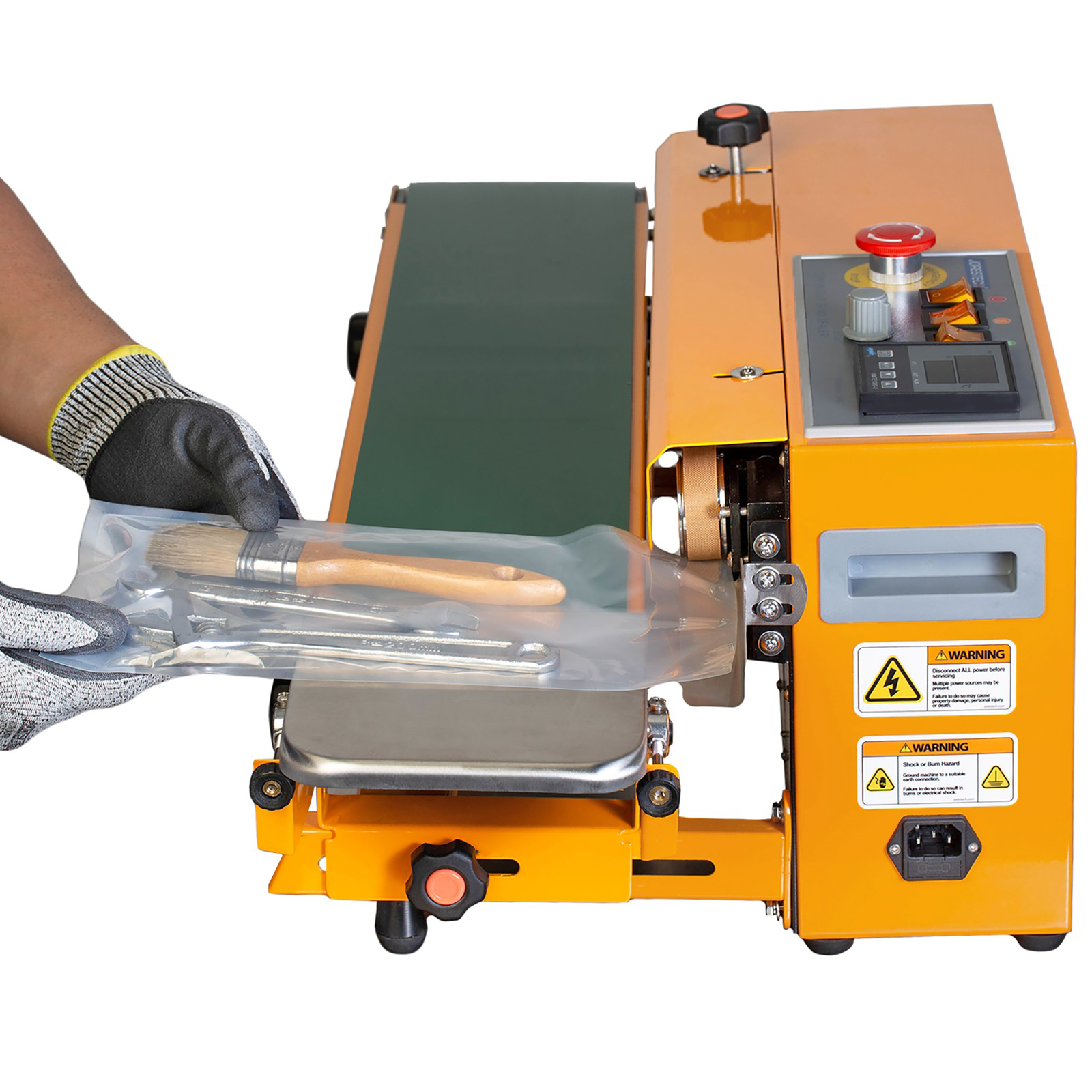The hands of a person operating the JORES TECHNOLOGIES® Horizontal Continuous Band Sealer. The worker is sealing a sealable bag with several tools inside.