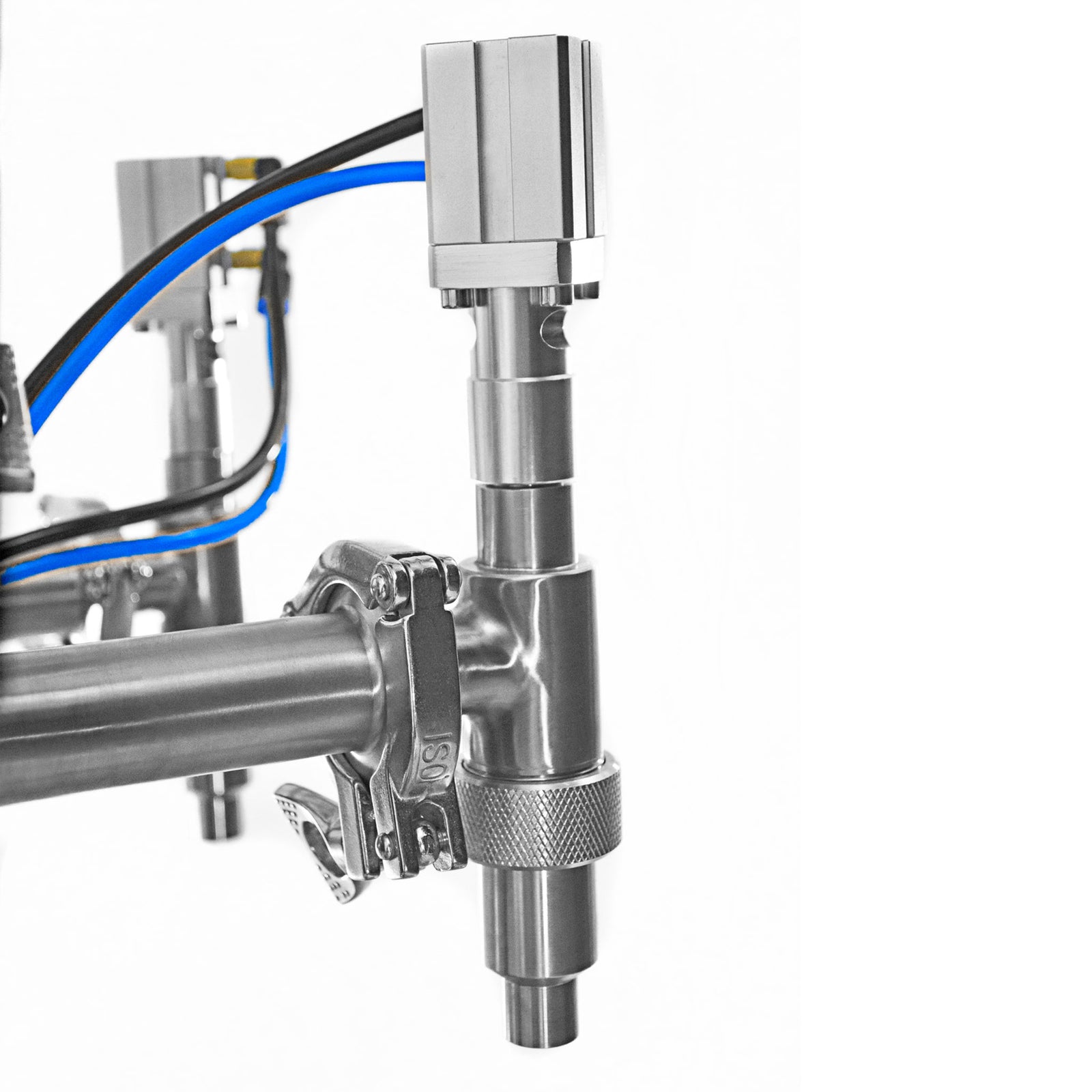 Closeup of the two stainless steel non-drip dispensing nozzles and pressured air hoses of the JORES TECHNOLOGIES® high viscosity piston filler