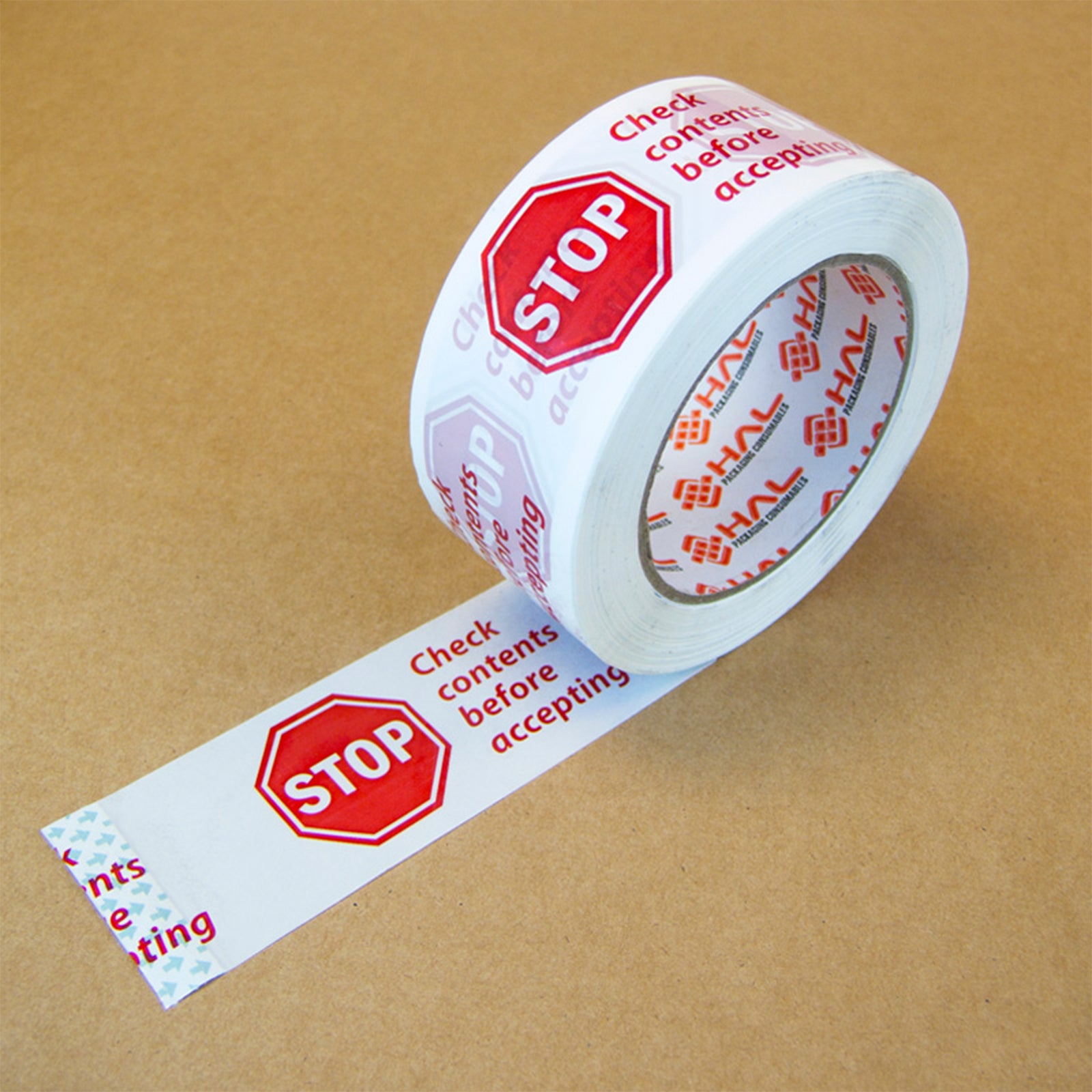 white roll of packaging tape with red stop sign and check contents before accepting message rolled onto brown box