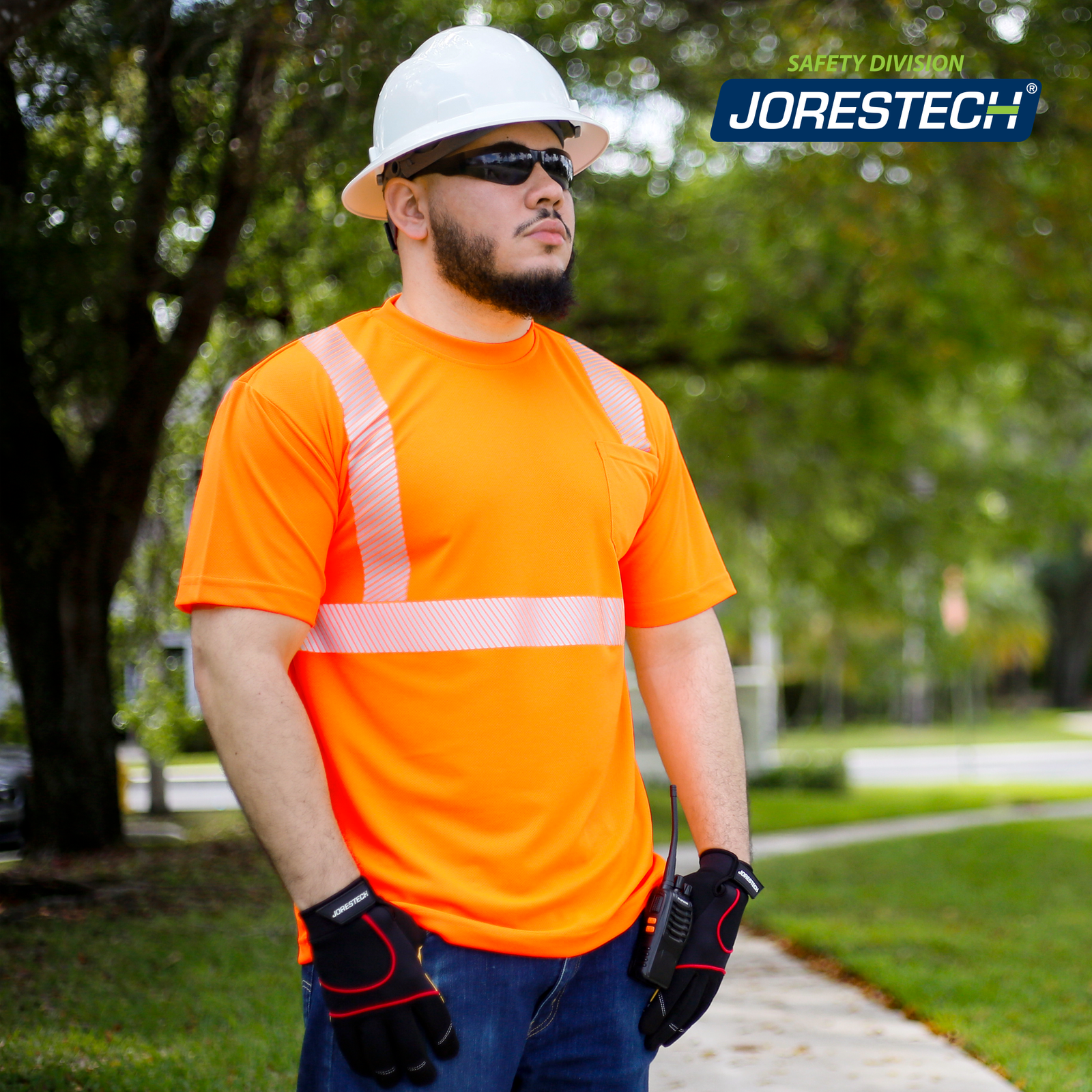 Worker standing near a road while wearing the high Vis segmented heat transfer reflective orange safety shirt with one chest pocket