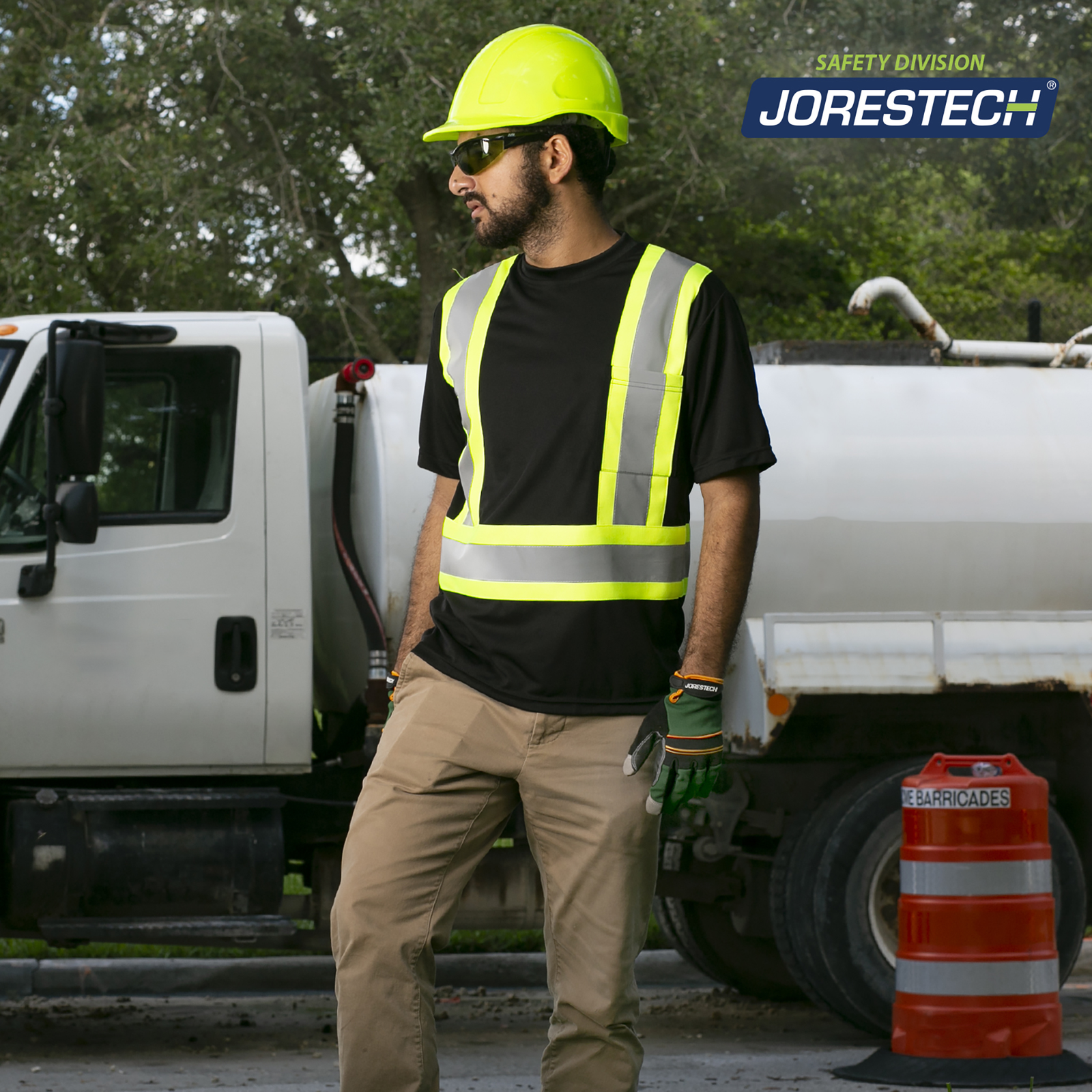 A worker wearing the  JORESTECH short sleeve Hi-vis reflective two tone safety black and yellow pocket shirt while driving a truck of potable water