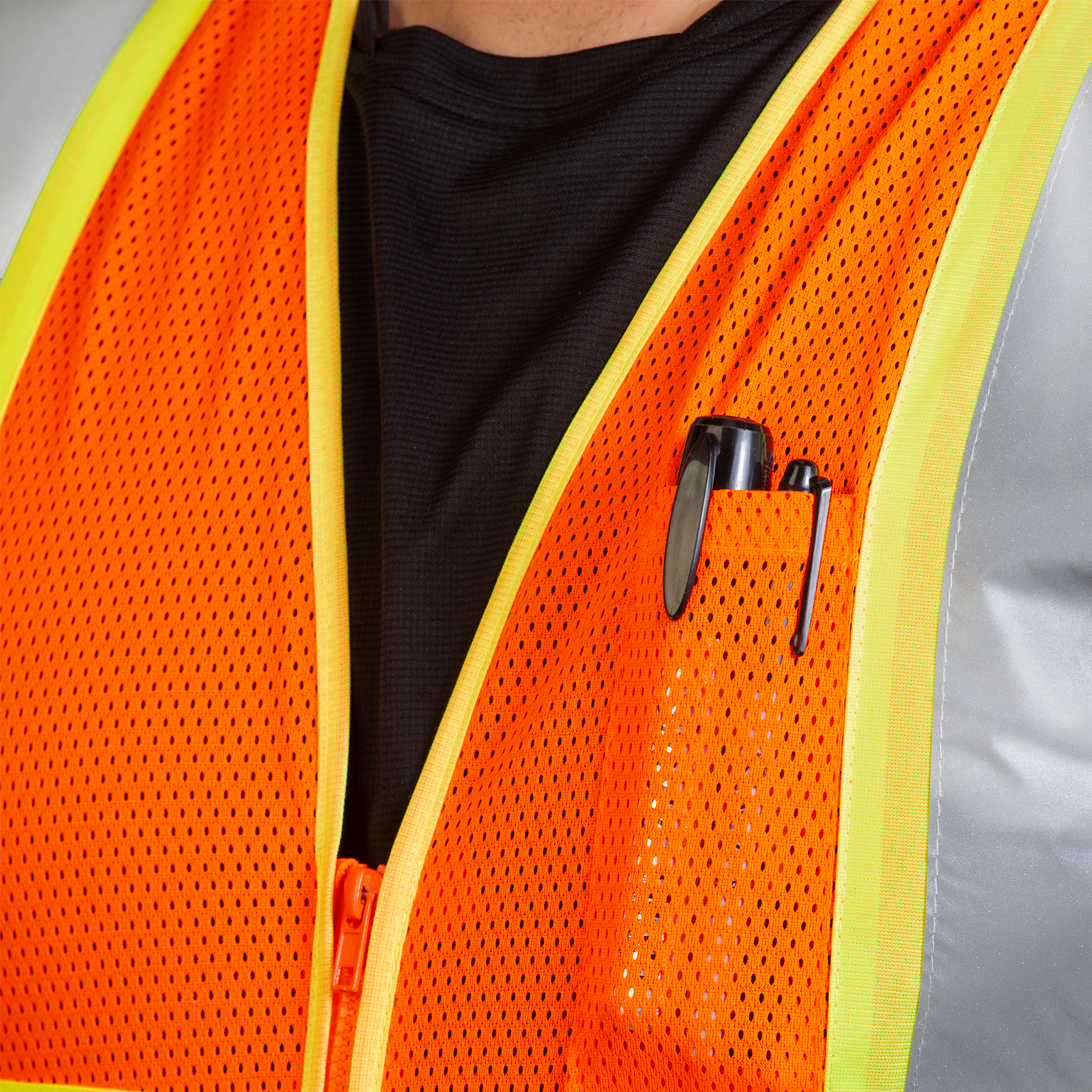 Close up of the chest pocket and two large markers inside of the JORESTECH orange safety vest