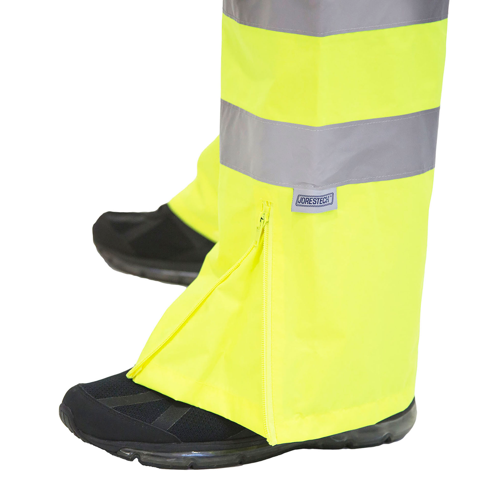 Close up of the High visibility all yellow/lime ANSI rain pants showing the zipper to expand pant to fit boots and shoes