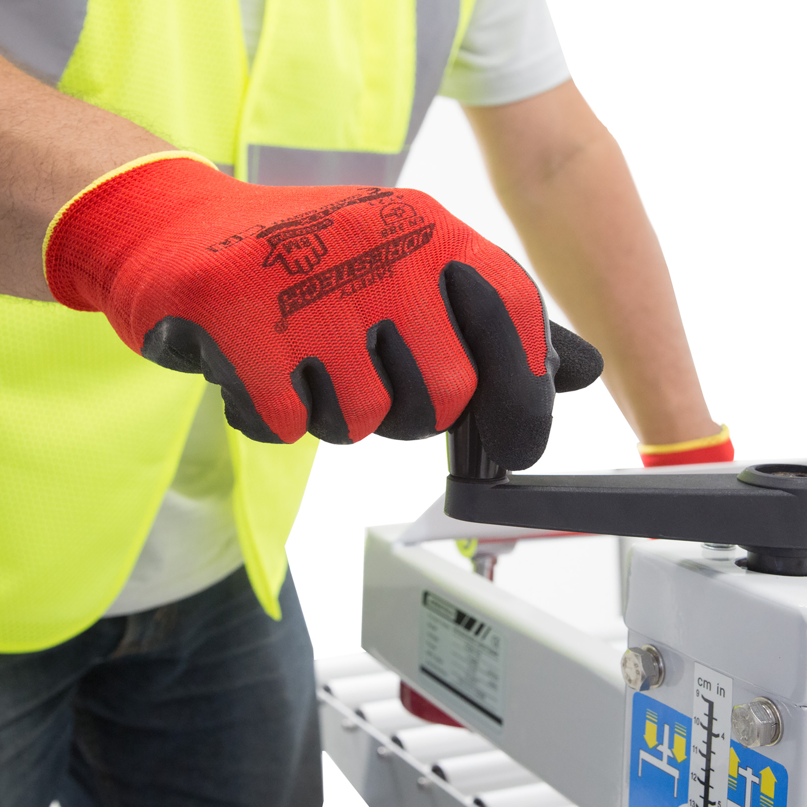 Worker wearing PPE and the JORESTECH red and black safety work gloves with latex dipped palms for mechanical work 