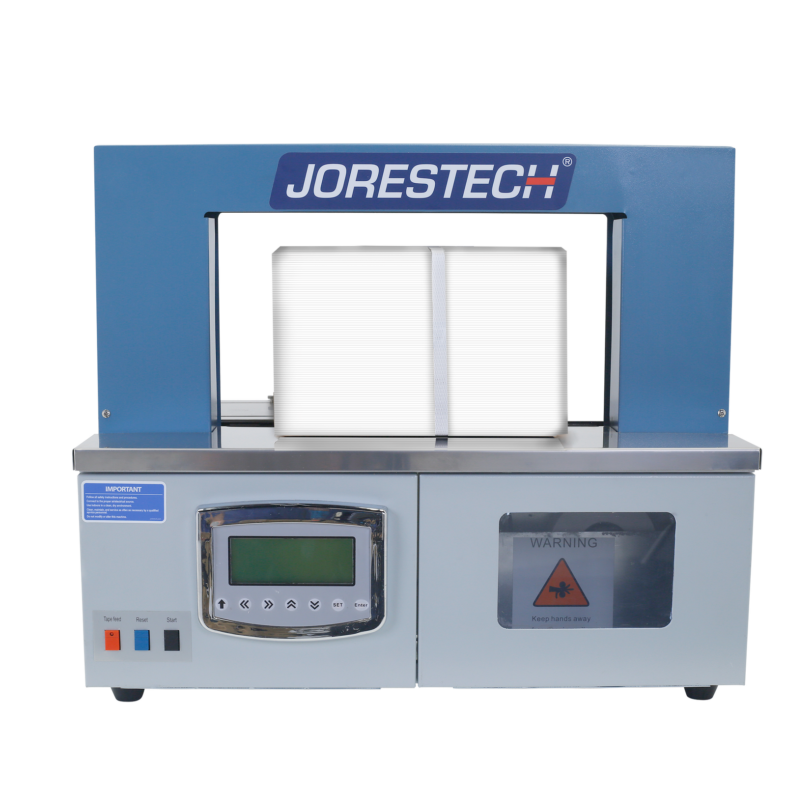 Front view of a grey and blue JORES TECHNOLOGIES® ® banding machine for papers and plastics. A white box can be seen on the sealing area with a white band around it. 