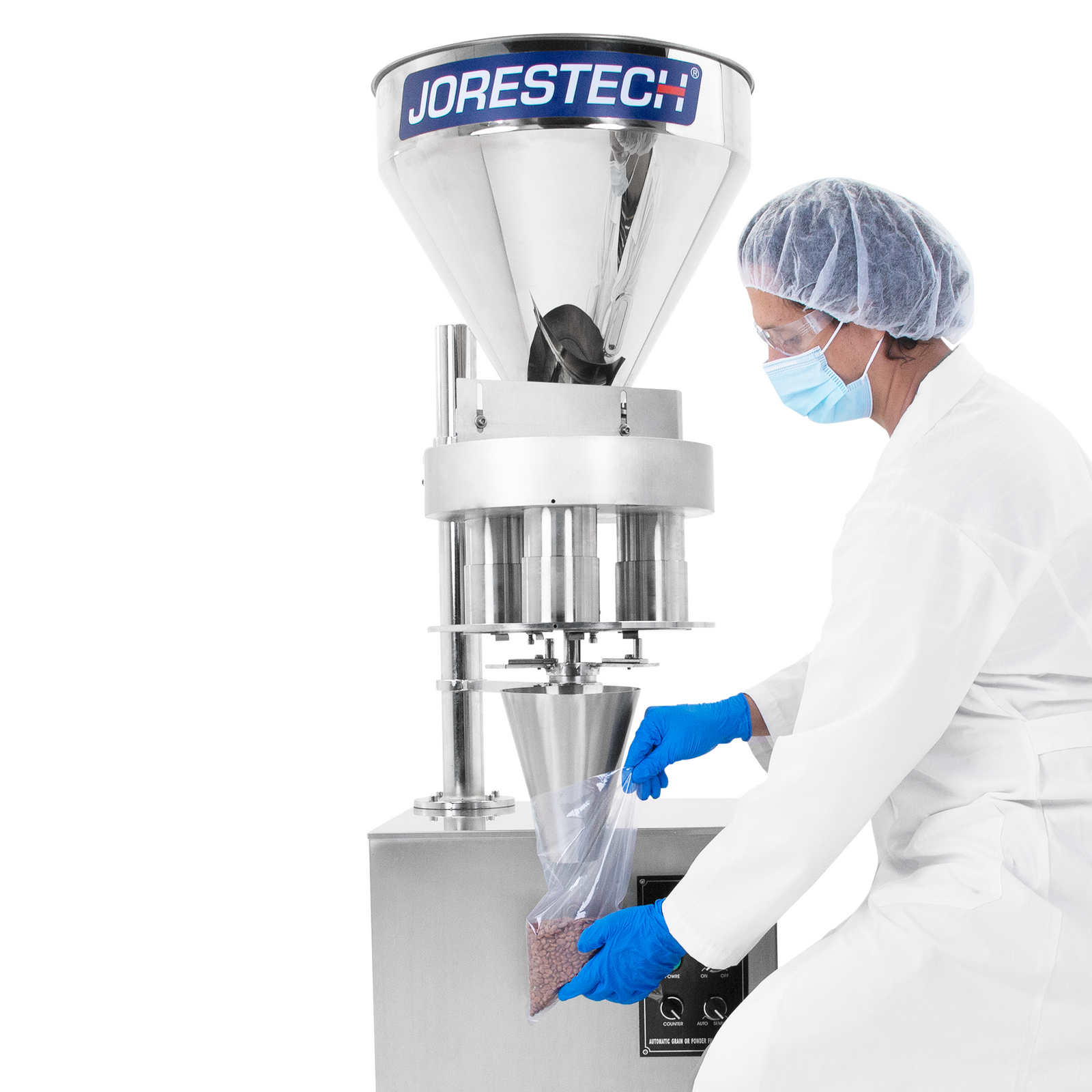 Worker holding a clear plastic bag under the dispensing cone while the gravity volumetric filler releases granular product with accuracy