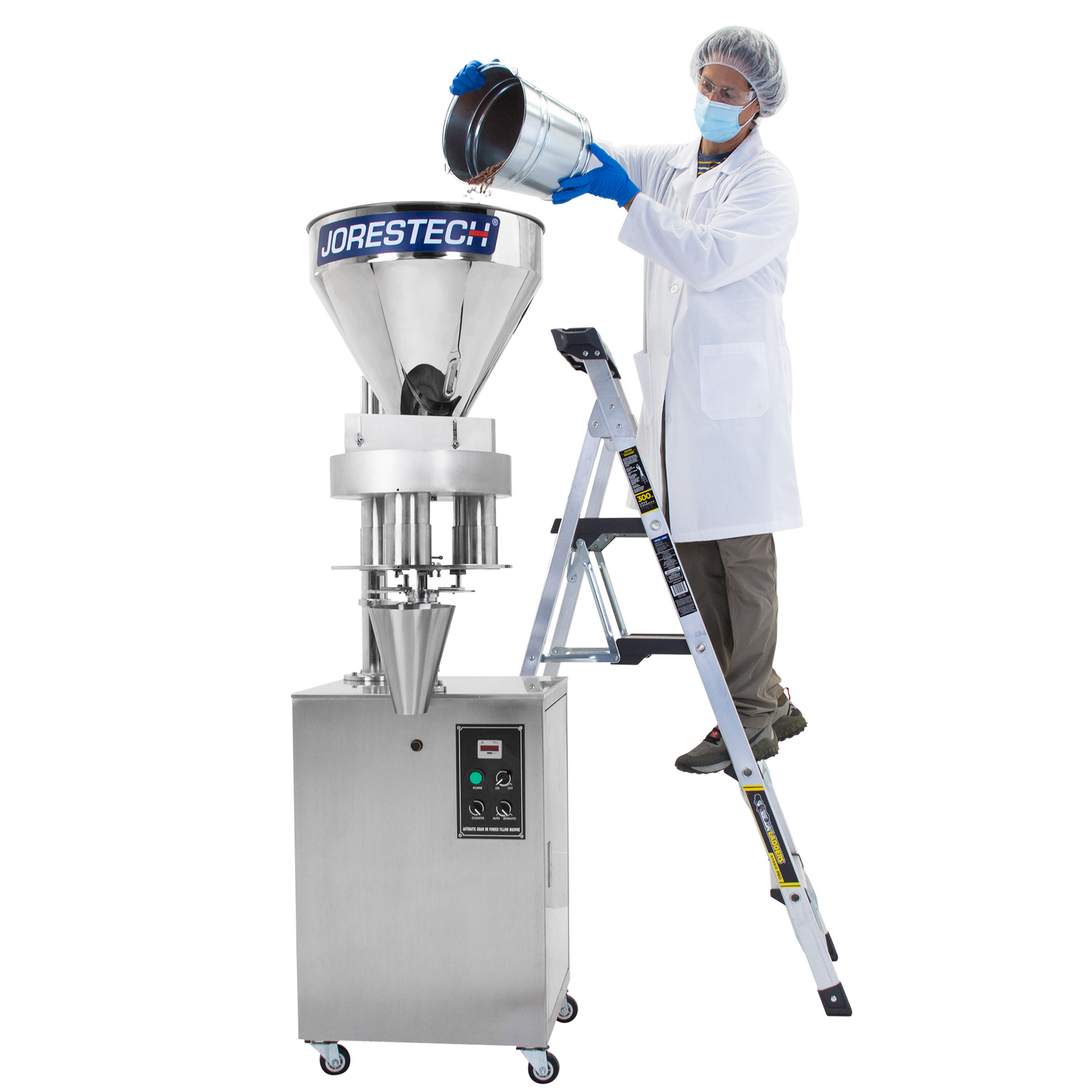 A worker standing on a ladder and dispensing a bucket full of beans into the stainless steel hopper of the JORES TECHNOLOGIES® semi automatic volumetric filler of 500ml