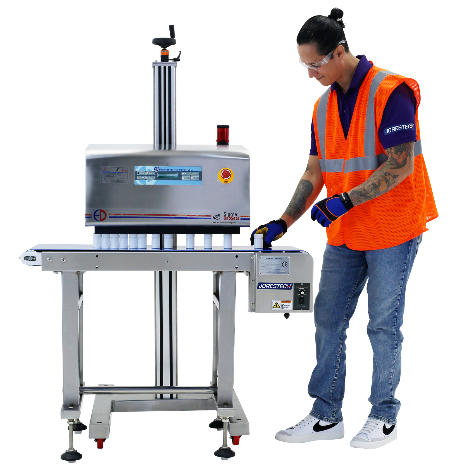 Operator wearing a high visibility orange vest can be seen placing white containers on a conveyor so that they can be sealed by an induction sealer for caps