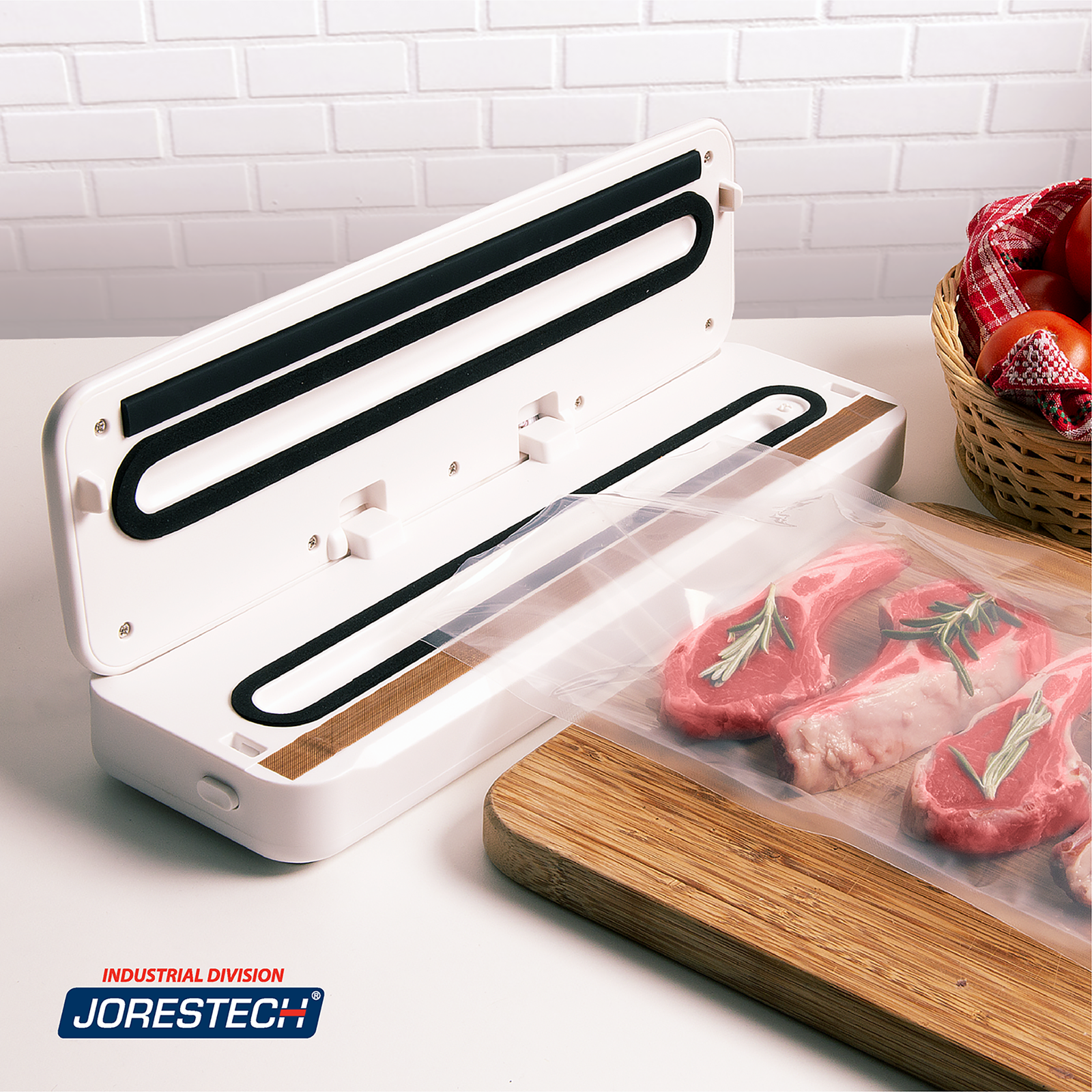 White JORES TECHNOLOGIES® vacuum sealing machine on the counter of a home kitchen. The machine is next to an open vacuum pouch full of red meat and rosemary that is placed on a wooden cutting board, ready to be sealed. 