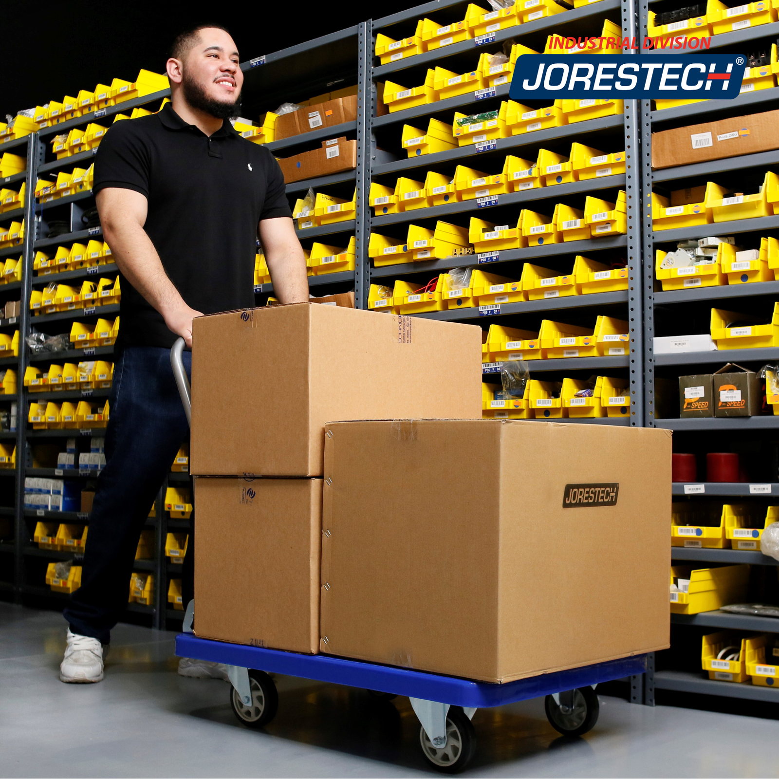 A man in a warehouse transporting large boxes with the JORES TECHNOLOGIES® foldable platform light weight cart 