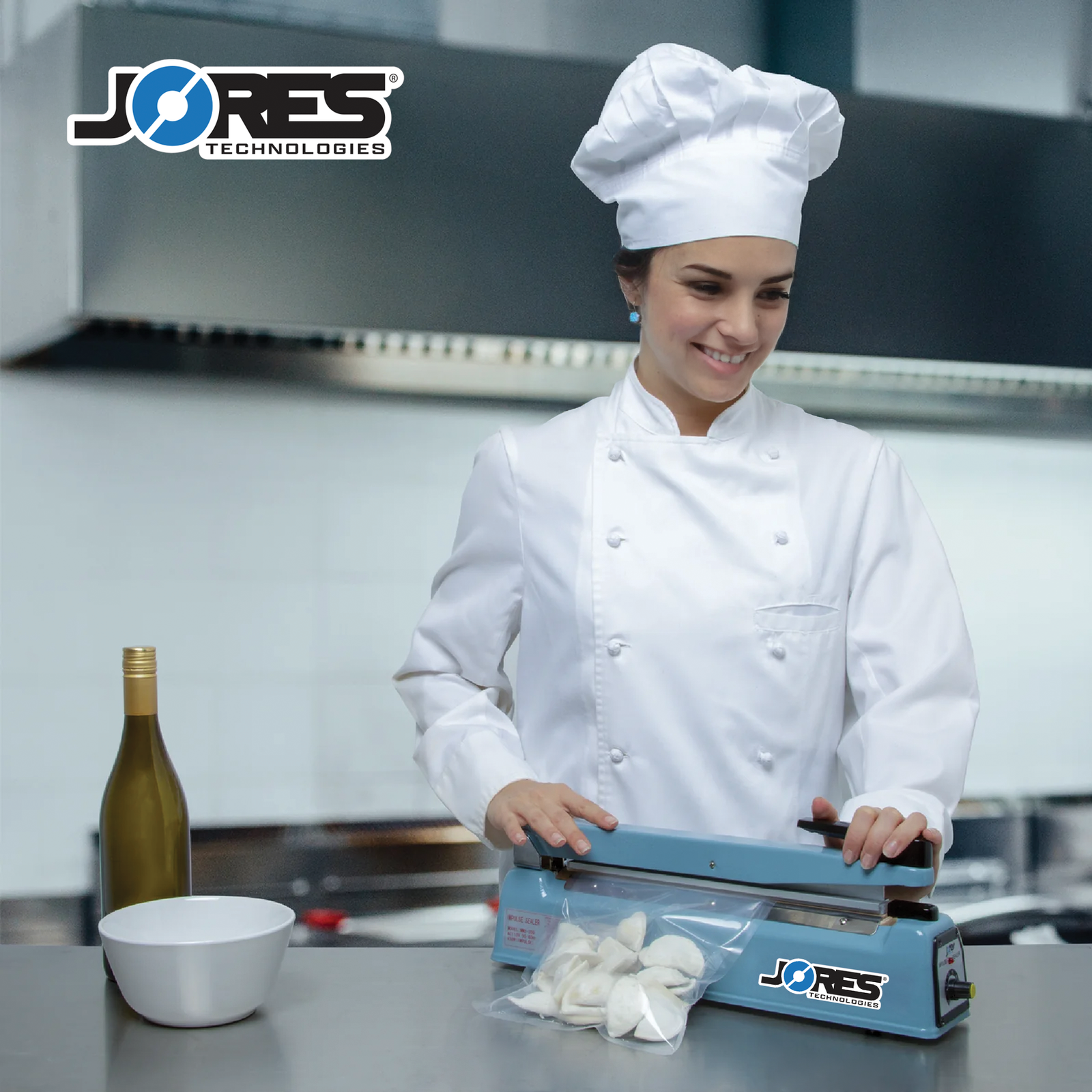 Young chef in an industrial kitchen sealing a sealable bag of dumplings with the JORES TECHNOLOGIES® 16 inch manual impulse bag sealer.