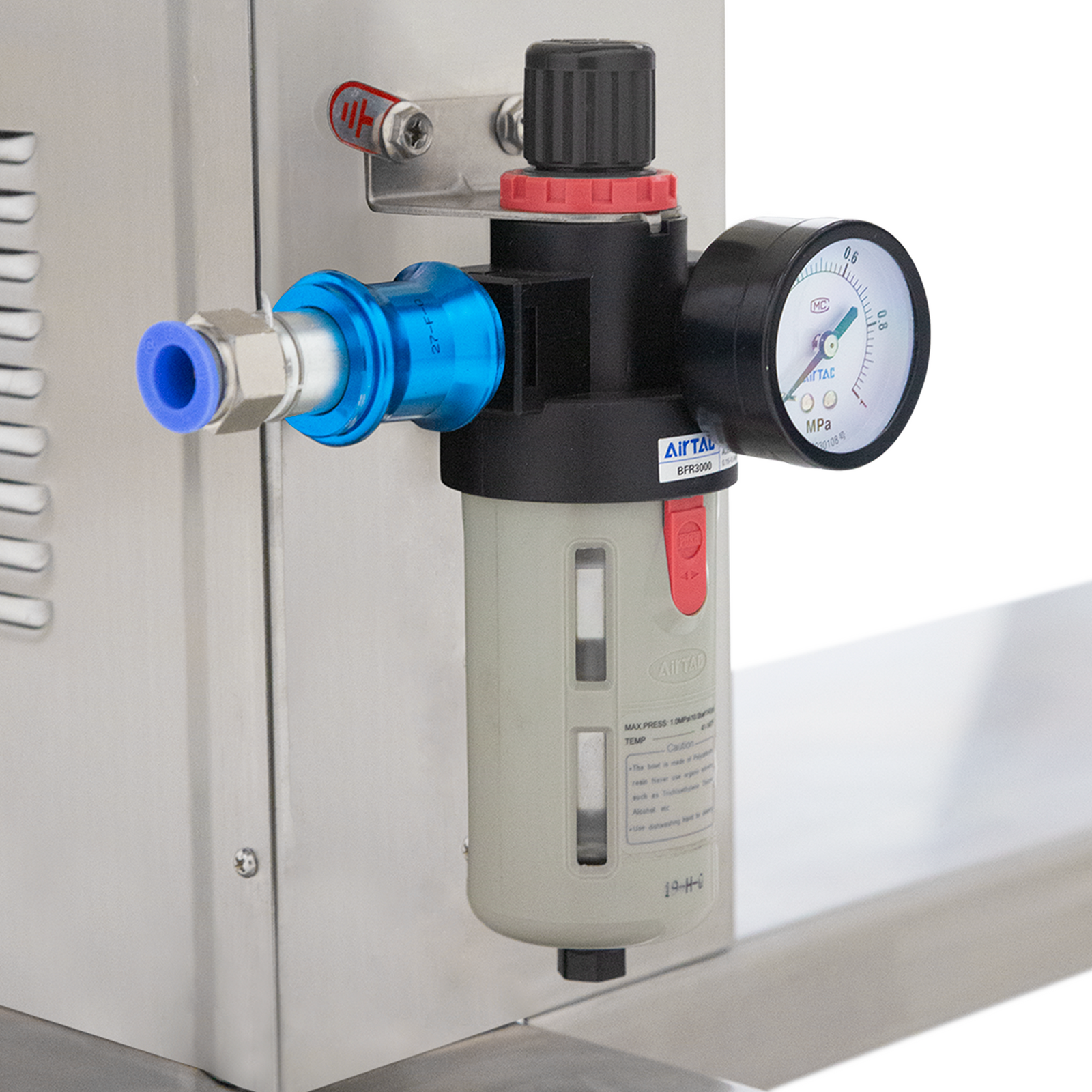 Close up of the compressed air regulator and valve of the automatic two head HV paste filling system for 1000ml