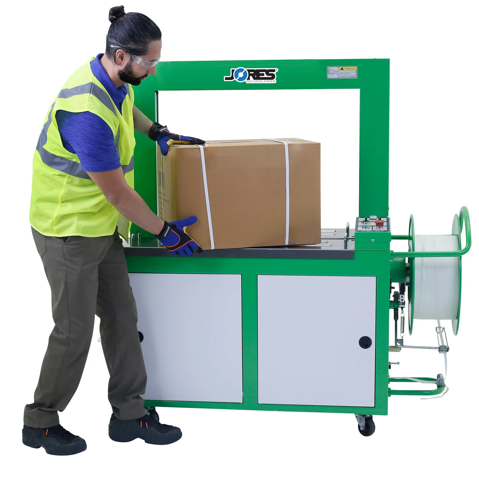 A worker removing a strapped card box from a JORES TECHNOLOGIES® automatic poly strapping machine