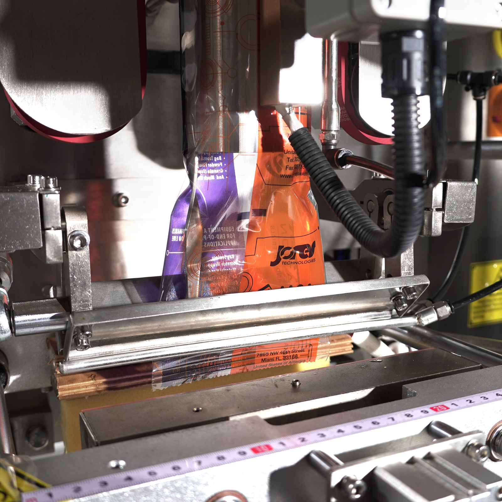 Filling and sealing mechanism on an automatic vertical pillow bag forming, filling and sealing machine for packaging by JORES TECHNOLOGIES