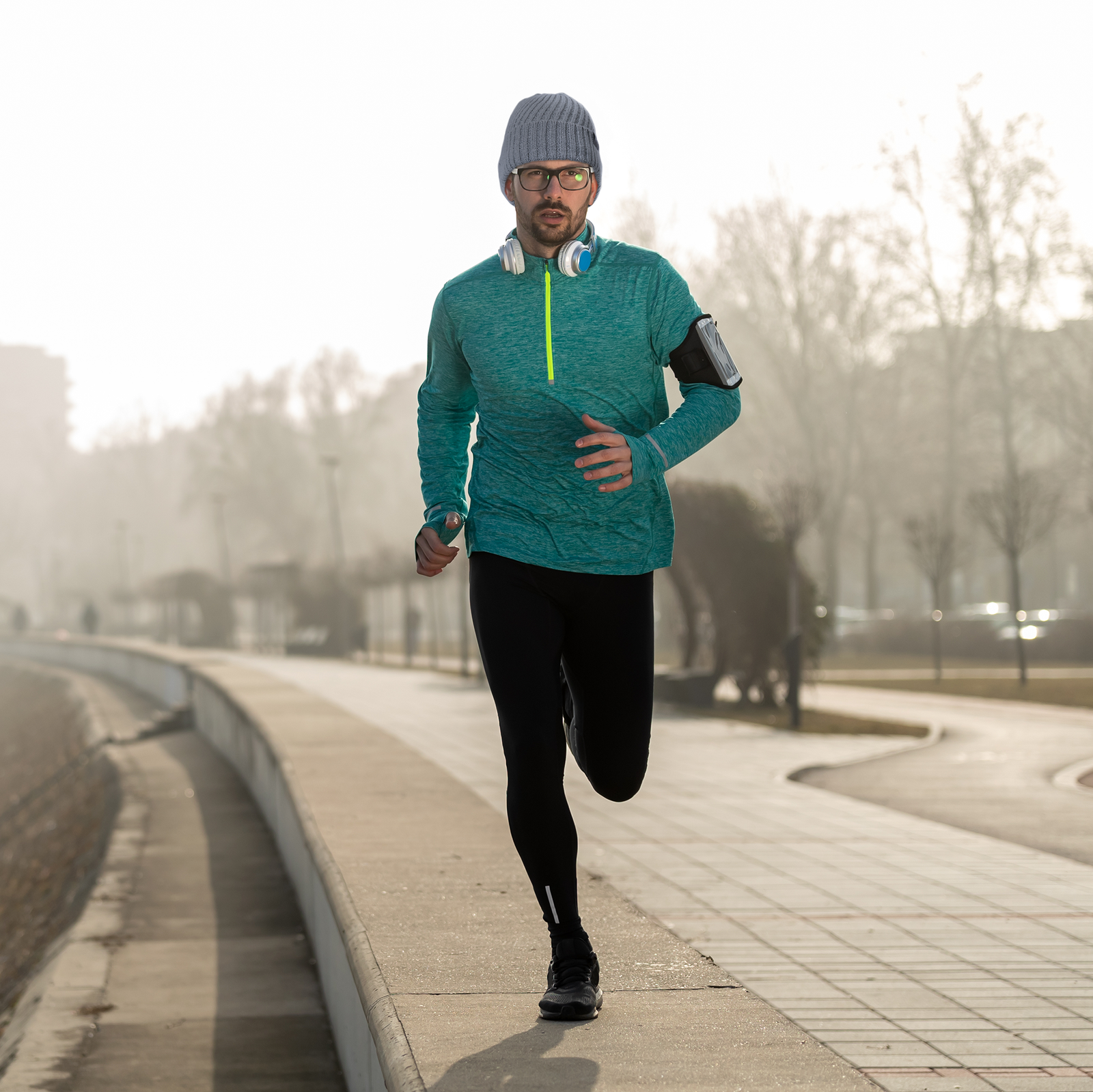 man jogging wearing the knitted beanie hat with reflective stitching