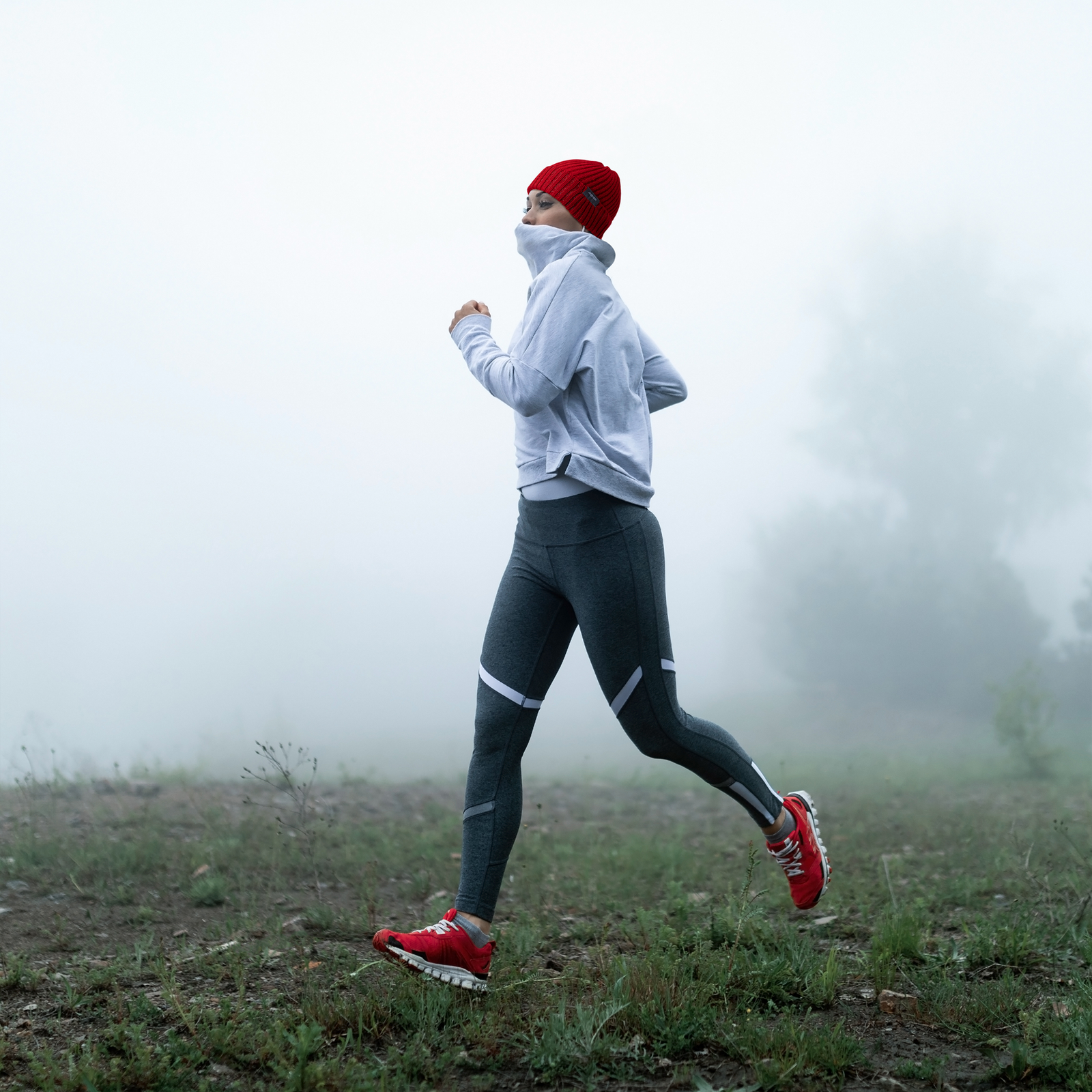 Woman using a red beanie hat for jogging
