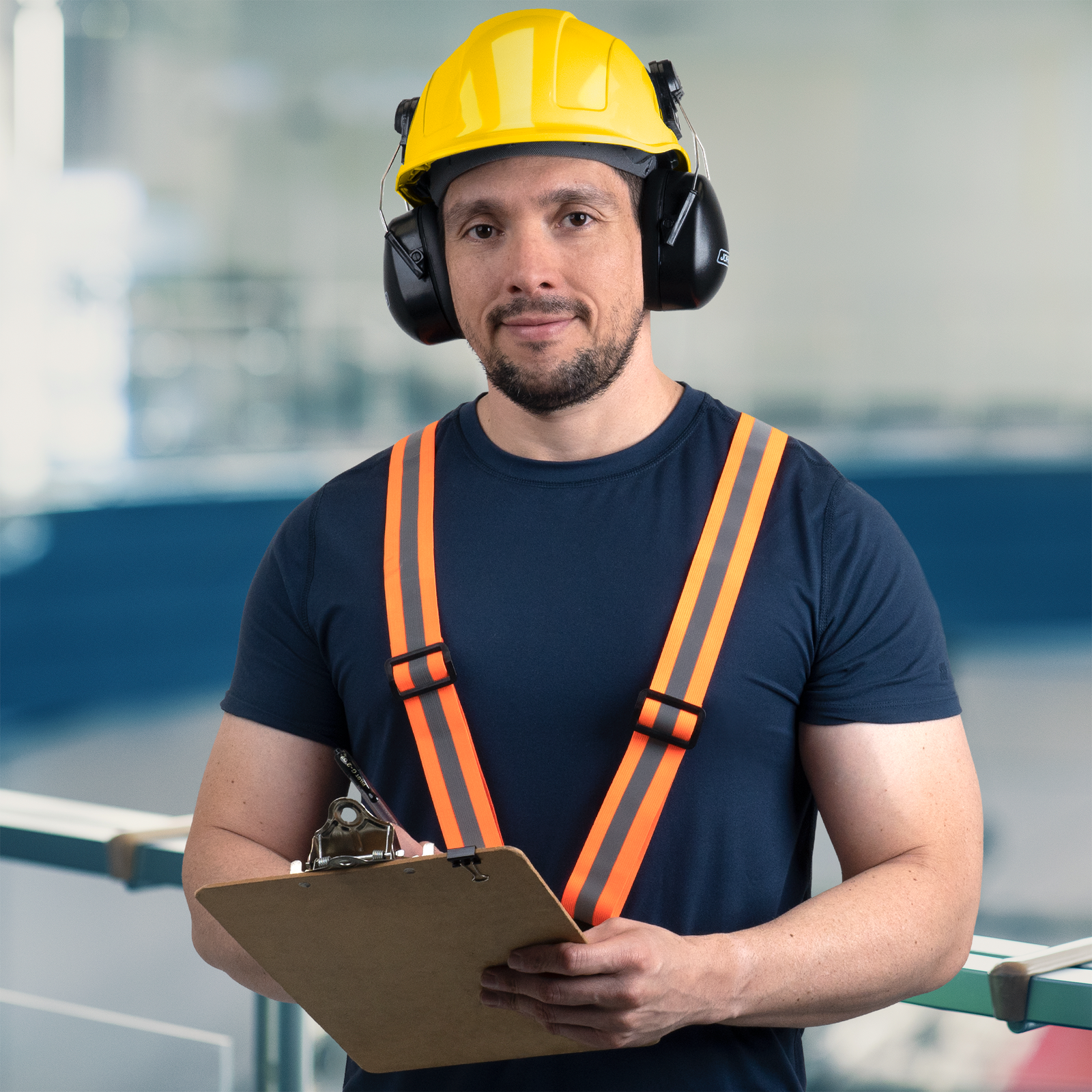 Worker wearing a slotted cap style hard hat with 4 point suspension and compatible ear muffs 