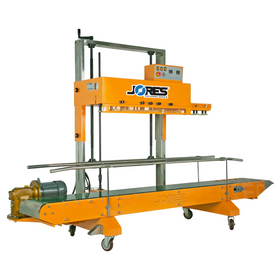 Diagonal view of the yellow heavy duty JORES TECHNOLOGIES® continuous band sealer with green revolving conveyor band and wheels