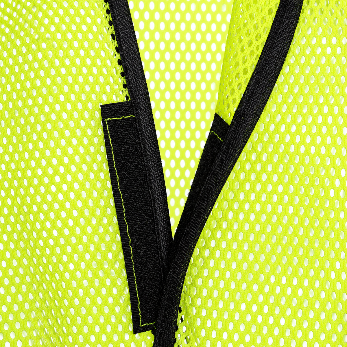 Close-up view of the black hook-and-loop front fastener strip on a JORESTECH lime-yellow mesh safety vest.