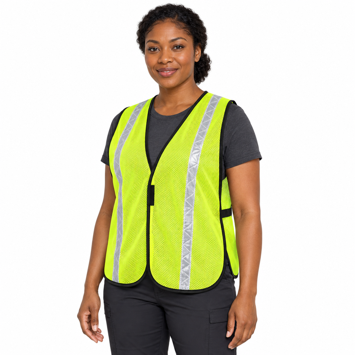 Female model in a high-visibility lime-yellow JORESTECH mesh safety vest, dark t-shirt, and cargo pants.
