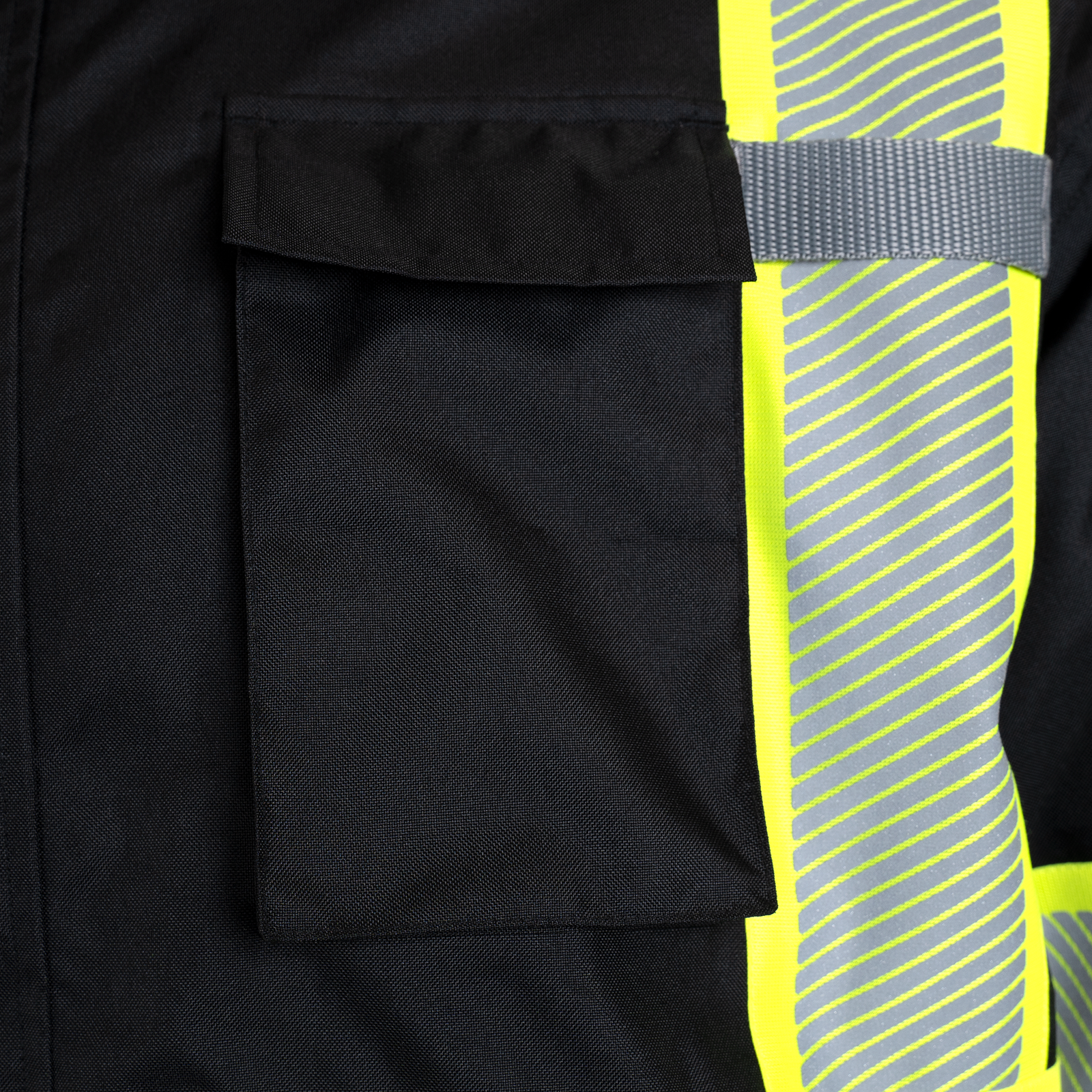 Close up shows the black reflective safety jacket with chest pocket and heat transfer tapes