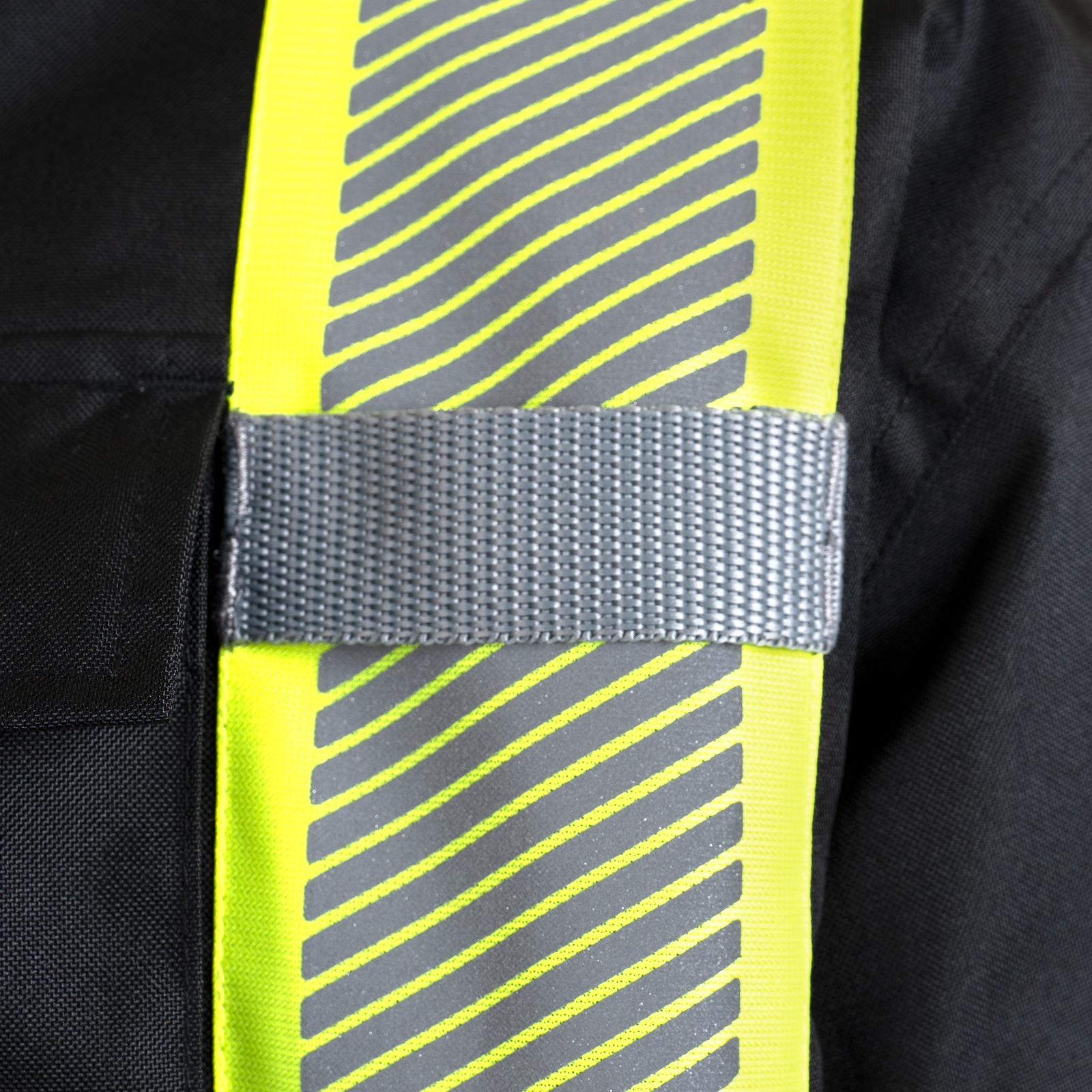 Black safety jacket with reflective strips and radio tabs
