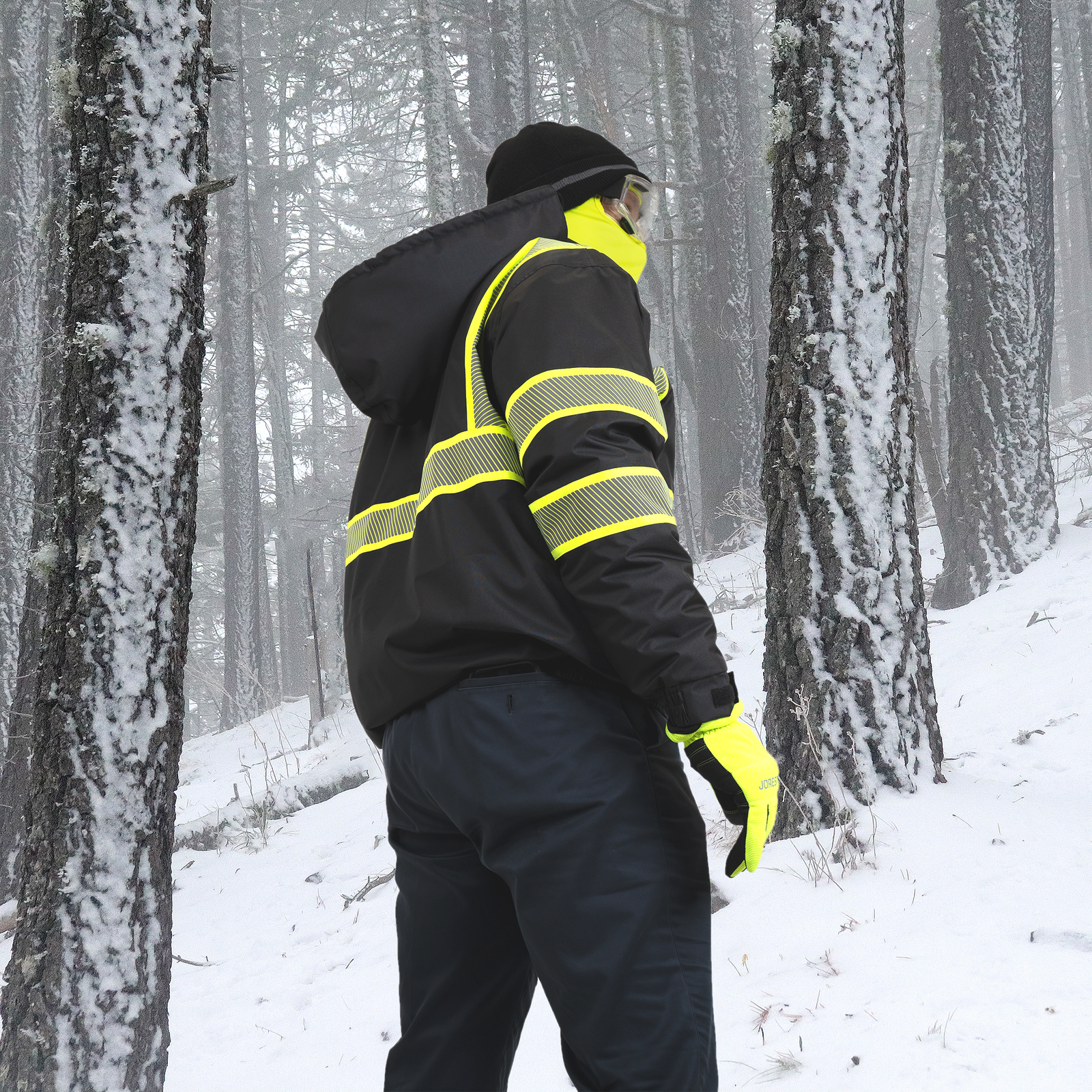 Man wearing the hi vis black safety jacket with heat transfer reflective tapes and removable hood for extreme cold weather
