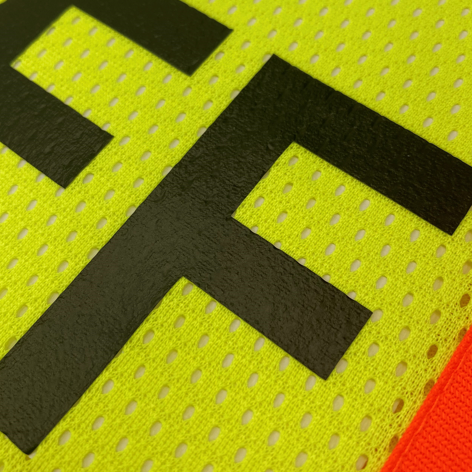 Close up of the yellow safety vest with reflective strips and mesh fabric for Staff workers