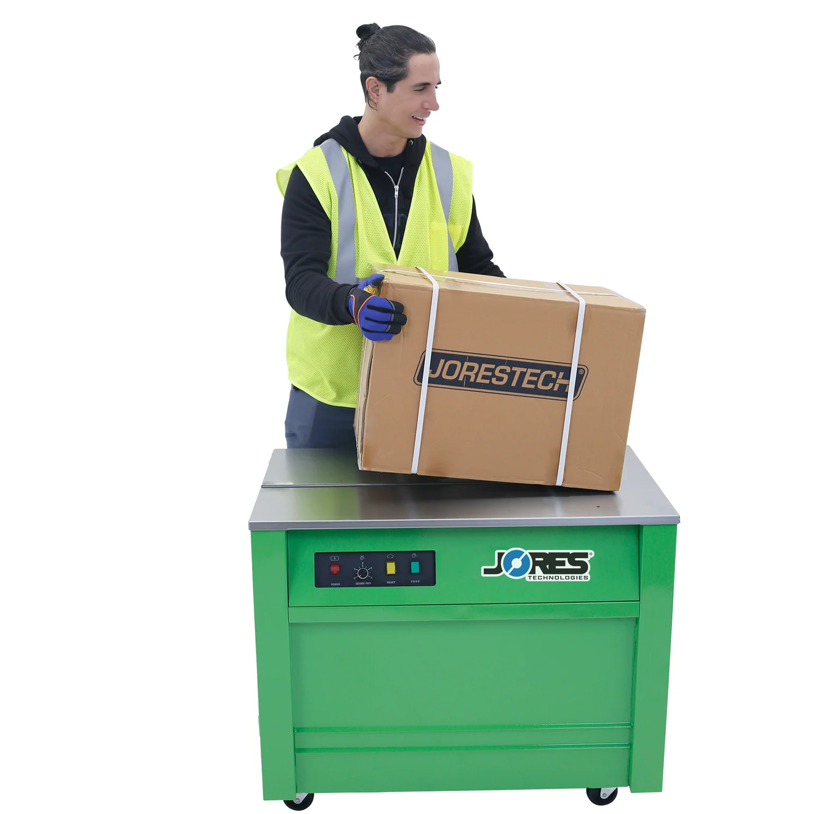 Worker operating a green JORES TECHNOLOGIES® semi automatic poly strapping machine with wheels. He has a carton box positioned on top of the machine with 3 poly straps securing the box around