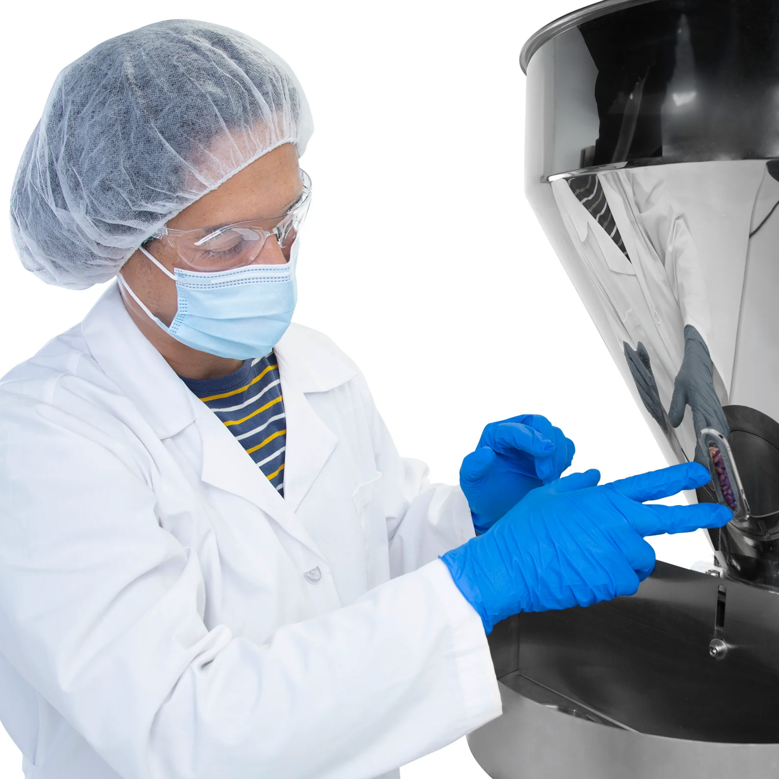 Man standing next to the semi automatic volumetric filler. He is checking the level of product remaining in the hopper through the inspection window