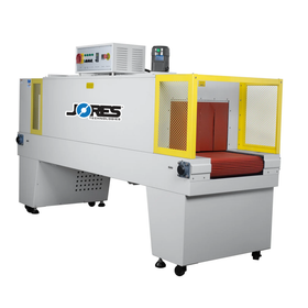 Diagonal view of a JORES TECHNOLOGIES® Shrink wrapping heat tunnel machine over white background.  Showing the entry conveyor, the insulation curtain, the control panel and one of the fan motors of the shrink tunnel.