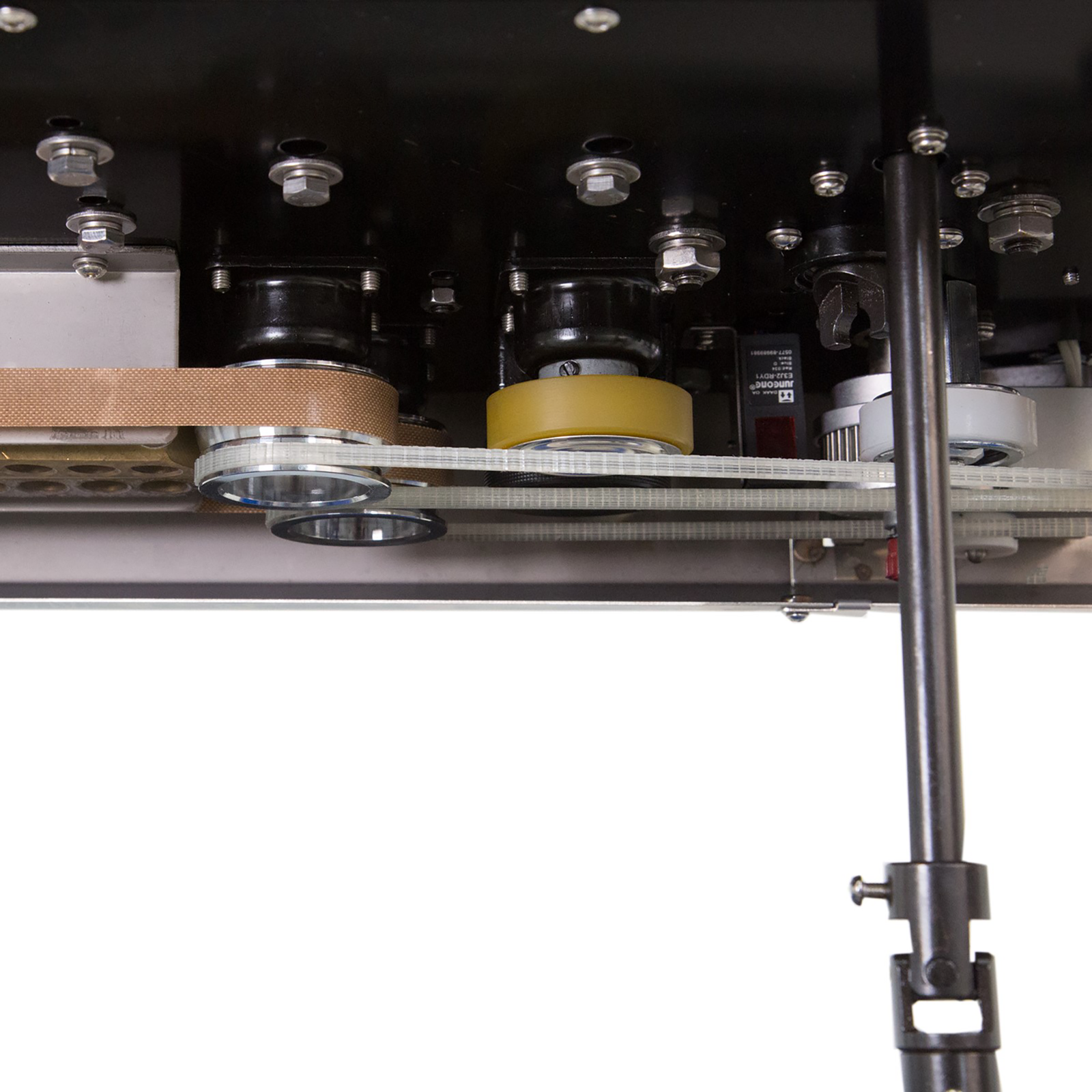 assortment of bands, heating elements and gear inside of a continuous band sealing mechanism