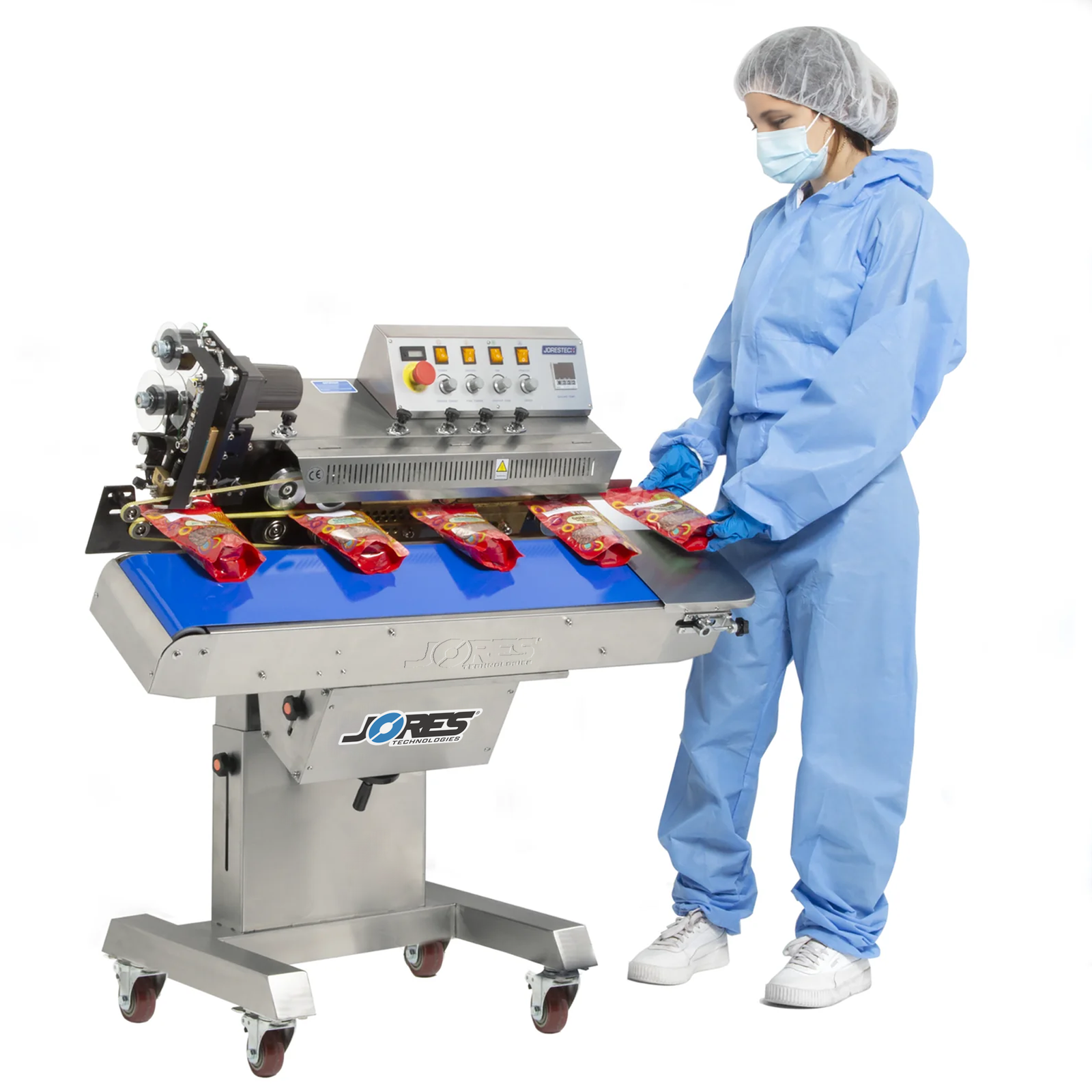 operator wearing blue overall inserting red plastic bag to be sealed and codded by stainless steel JORES TECHNOLOGIES® continuous band sealer. All the machine except the base is tilted forward showing that the machine can be adjusted to horizontal or to a tilted position