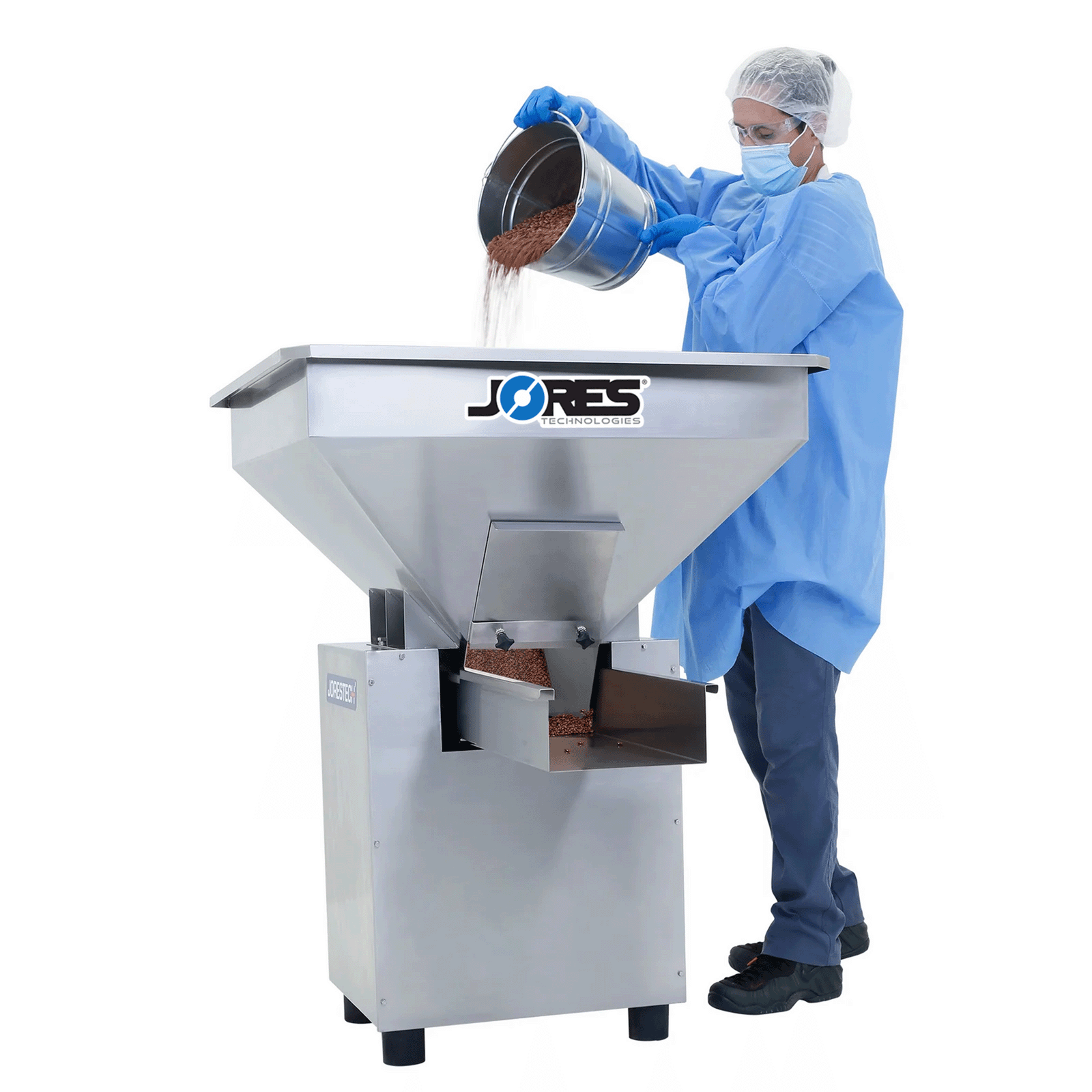 A worker  pouring red grains into the hopper of a JORES TECHNOLOGIES® stainless steel vibratory hopper feeder.