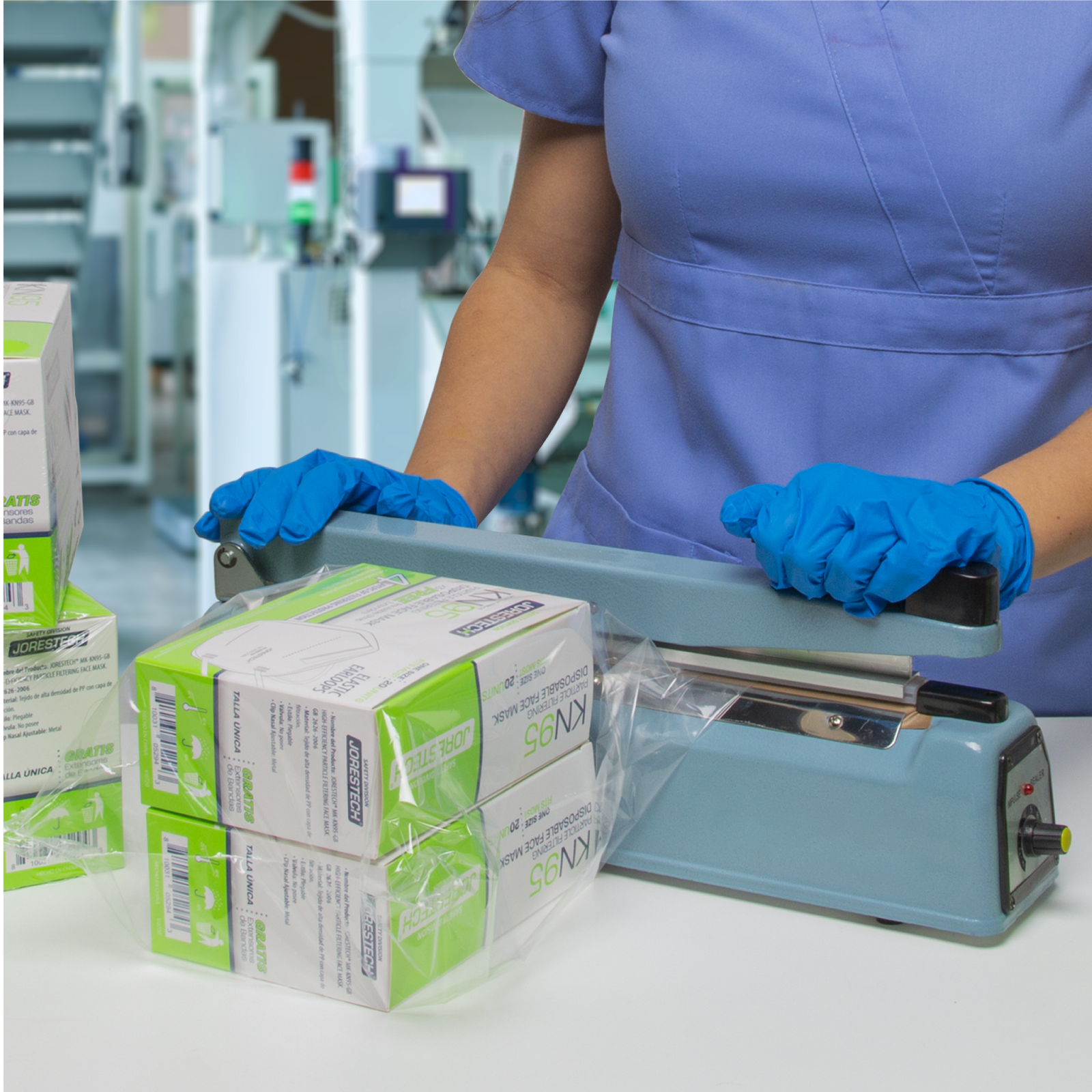 Medical environment. A nurse is sealing a sealable bag with two boxes of face masks using the 12 inch manual impulse sealer