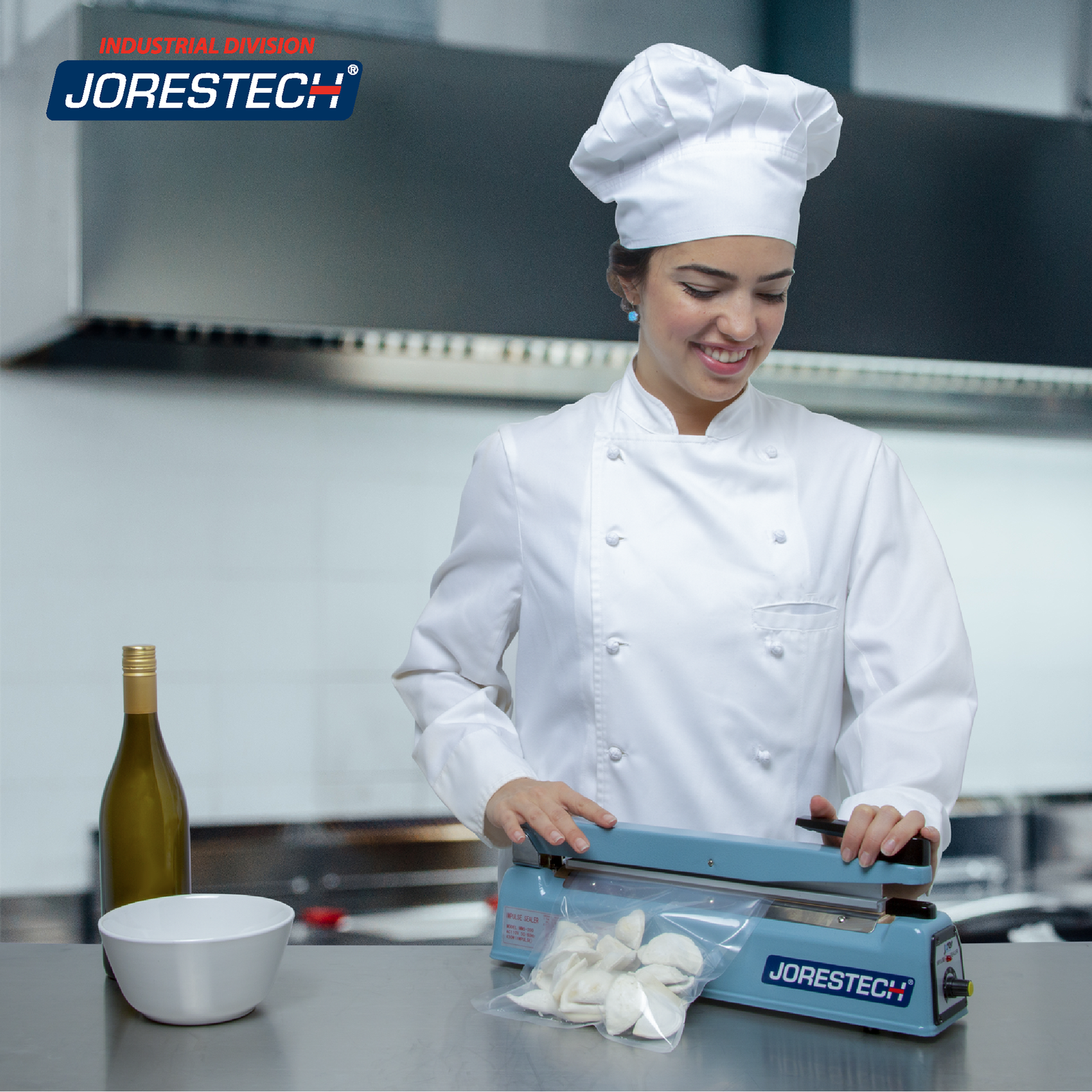 Young chef in an industrial kitchen sealing a sealable bag of dumplings with the JORES TECHNOLOGIES® 16 inch manual impulse bag sealer.