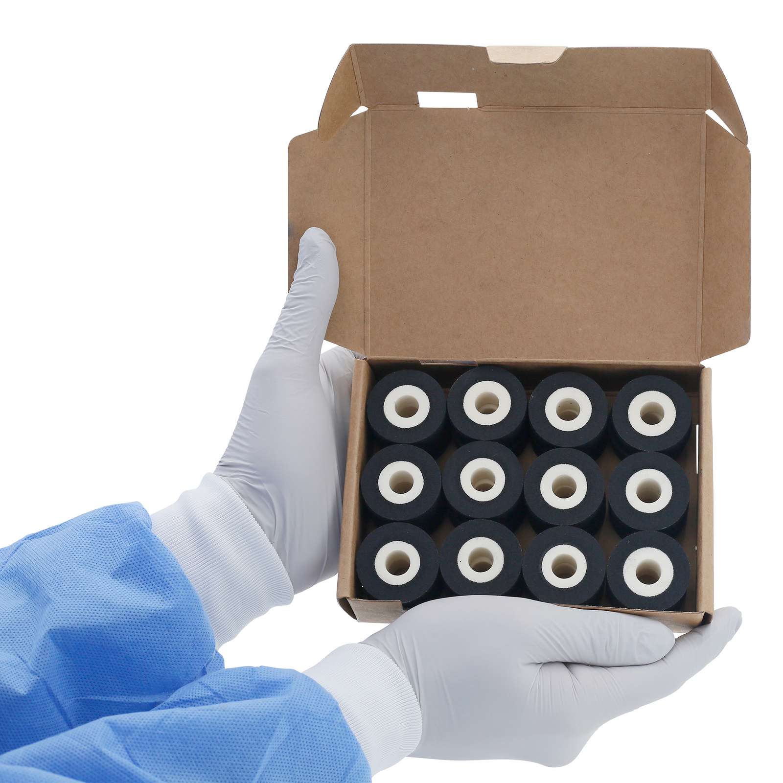 A person holding a card box open with 24 16mm black hot DAX ink rolls inside