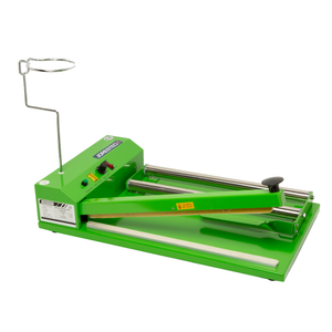 Green JORESTECH shrink sealing system with a shrink roll holder, impulse sealer, and heat gun receptacle over a white background.