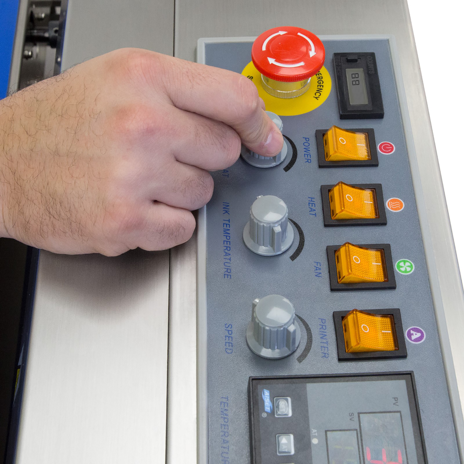 operator adjusting a dial on the control panel of a stainless steel JORESTECH continuous band sealer to start sealing plastic bags