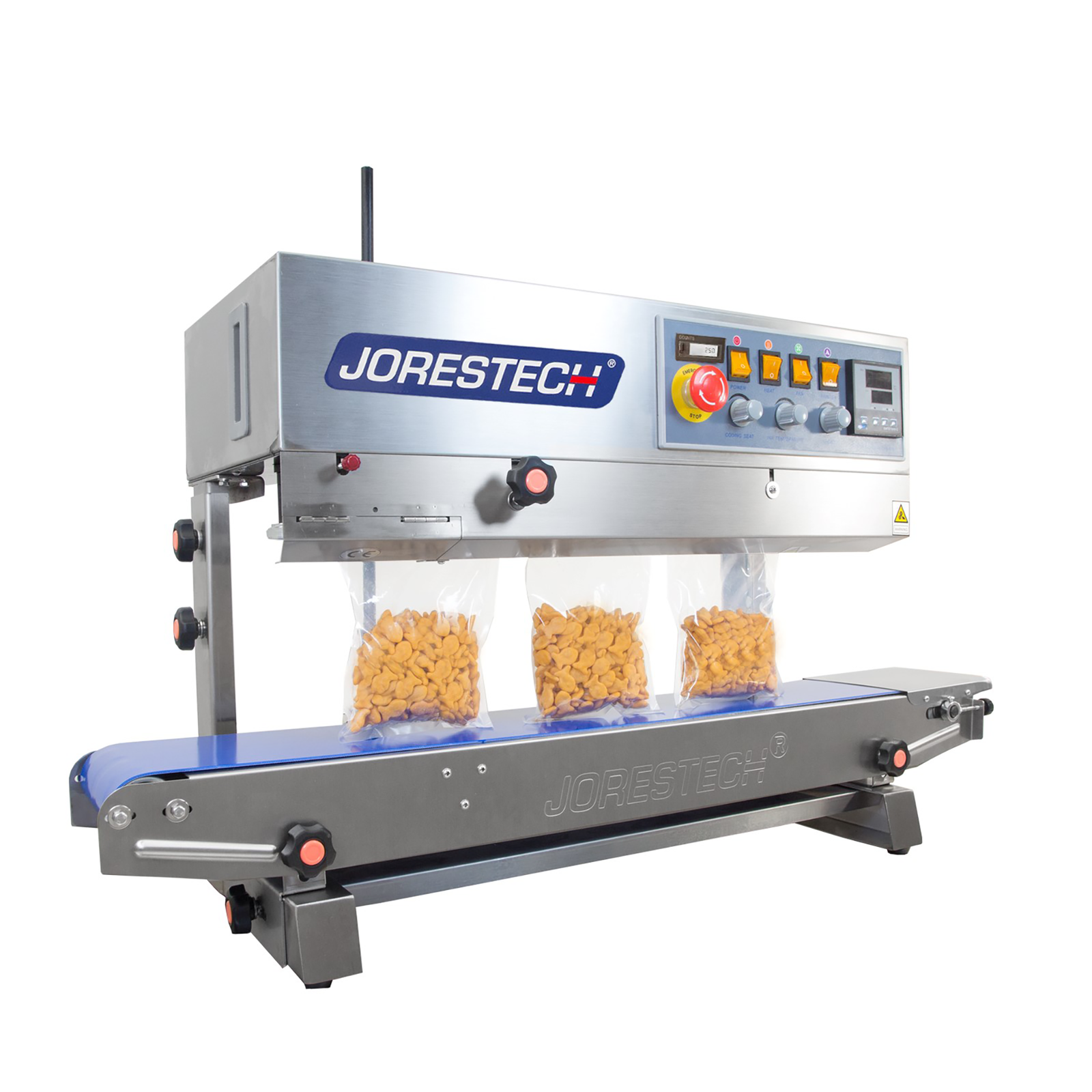 stainless steel JORESTECH continuous band sealer sealing several plastic bags filled with orange crackers