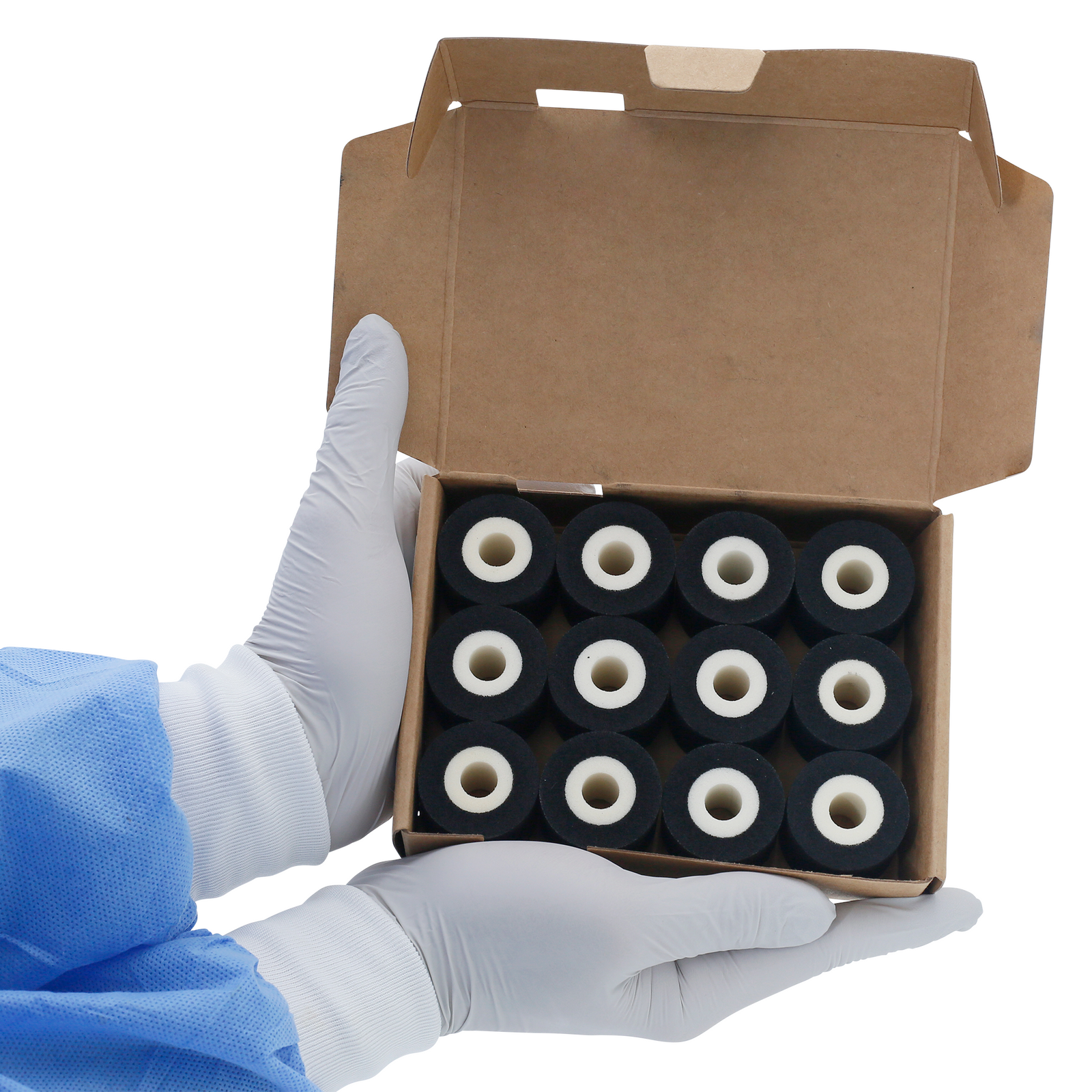 A person holding a card box open with 12 32mm black hot DAX ink rolls inside.