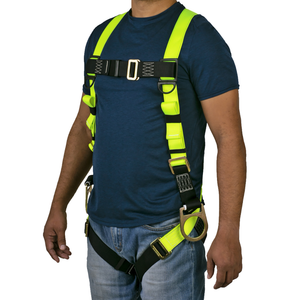 Front view of the torso of a person wearing the hi-vis yellow and black 3D fall protection safety body JORESTECH harness over white background
