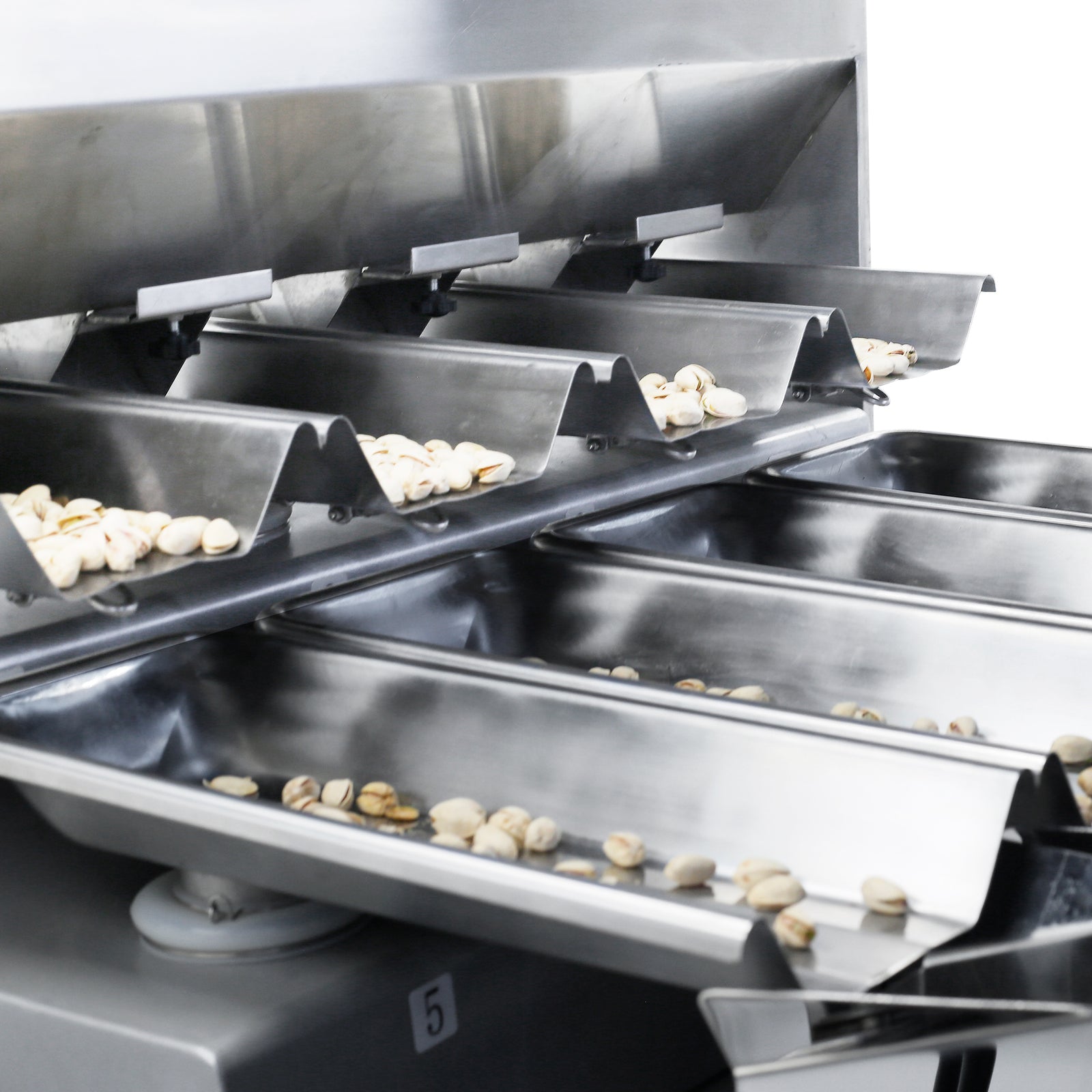 closeup of the JORES TECHNOLOGIES® linear weigher dispensing pistachios