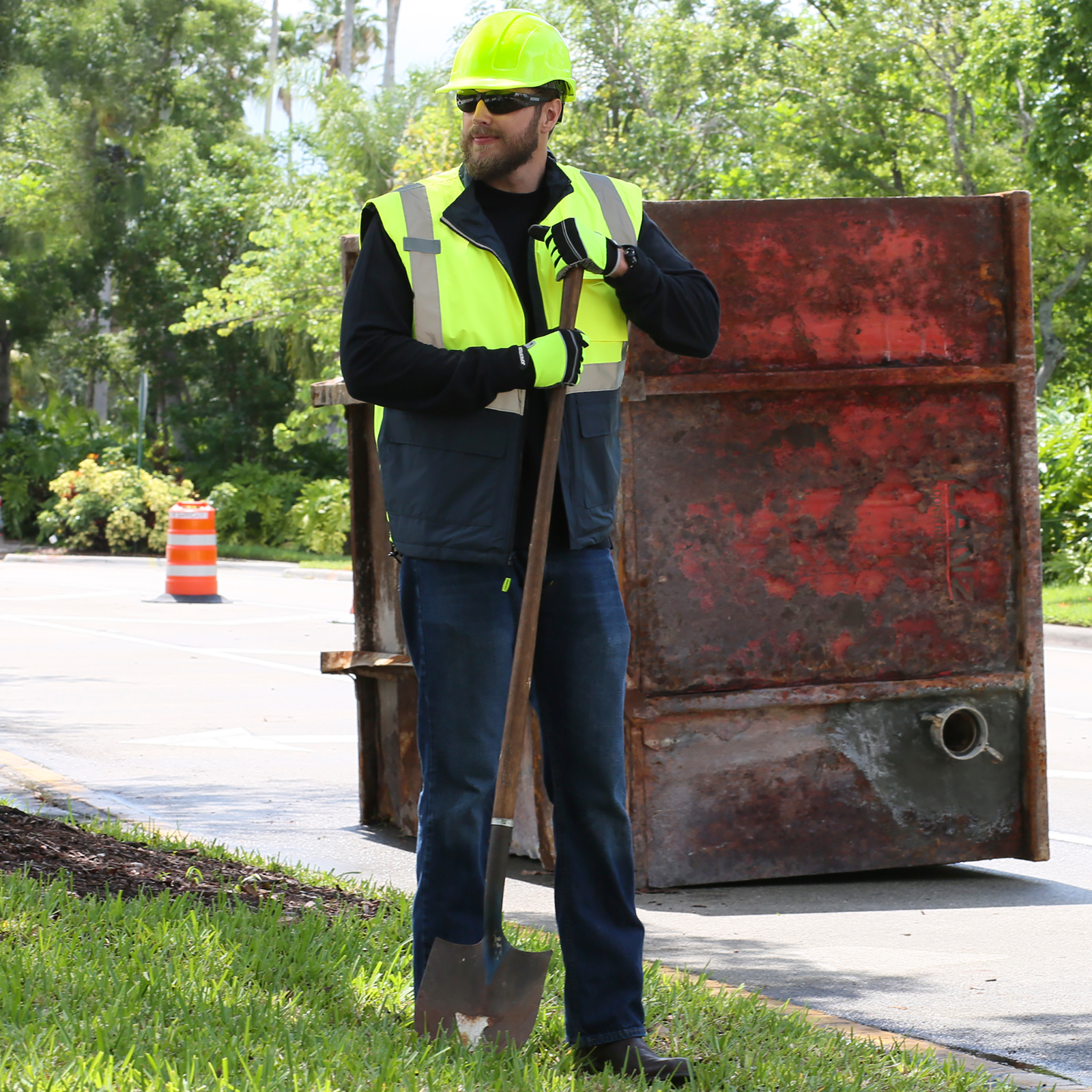 Man wearing the reflective safety vest while he is in a road construction or repair