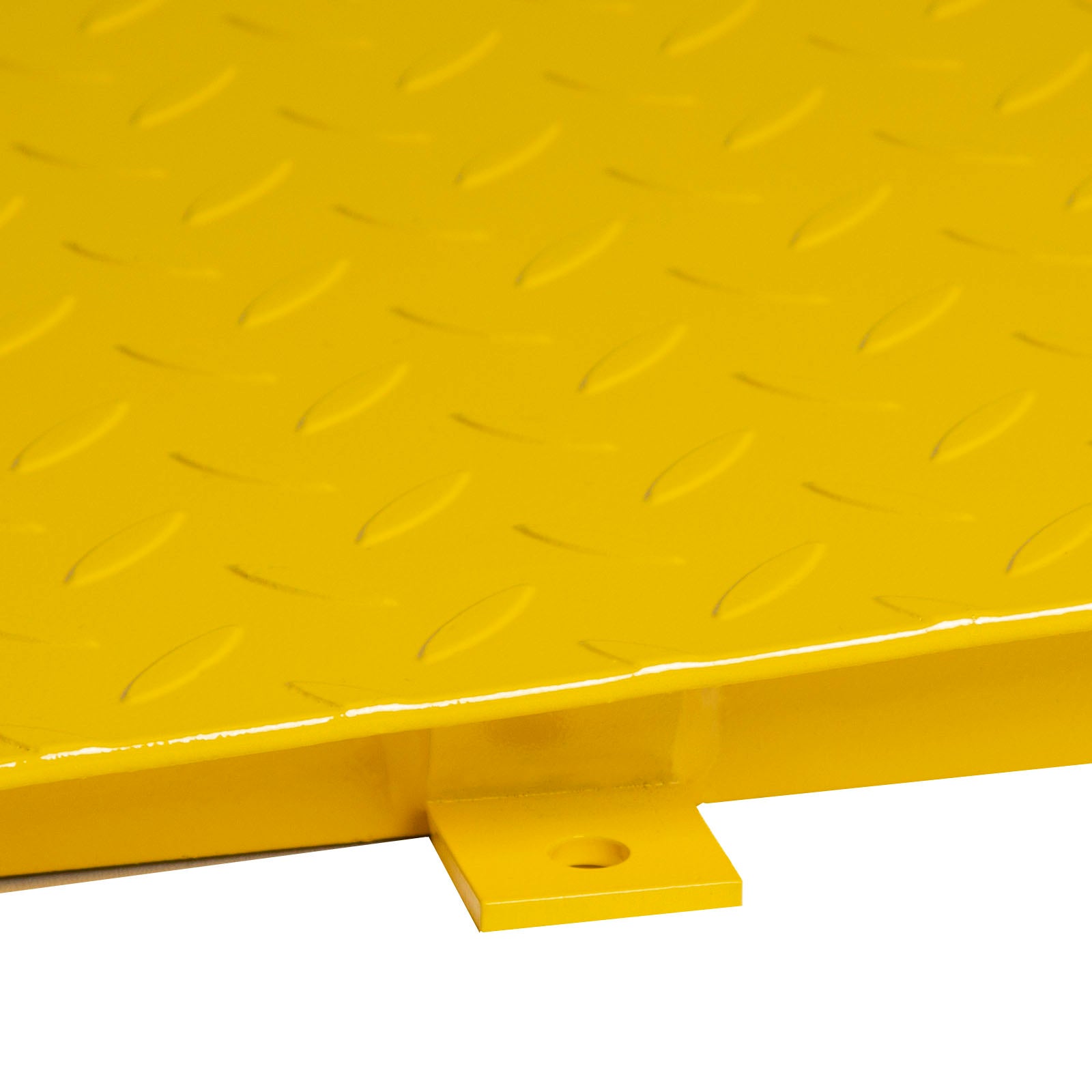 Close-up of one of a yellow metallic approach ramp's four lateral holds.